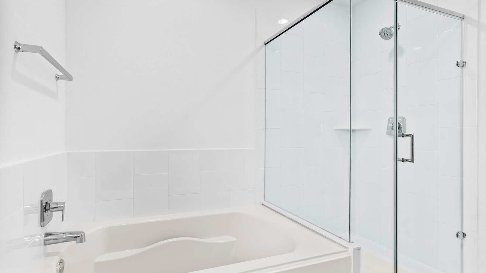 Primary bathroom with a glass-enclosed standing shower and separate soaking tub.