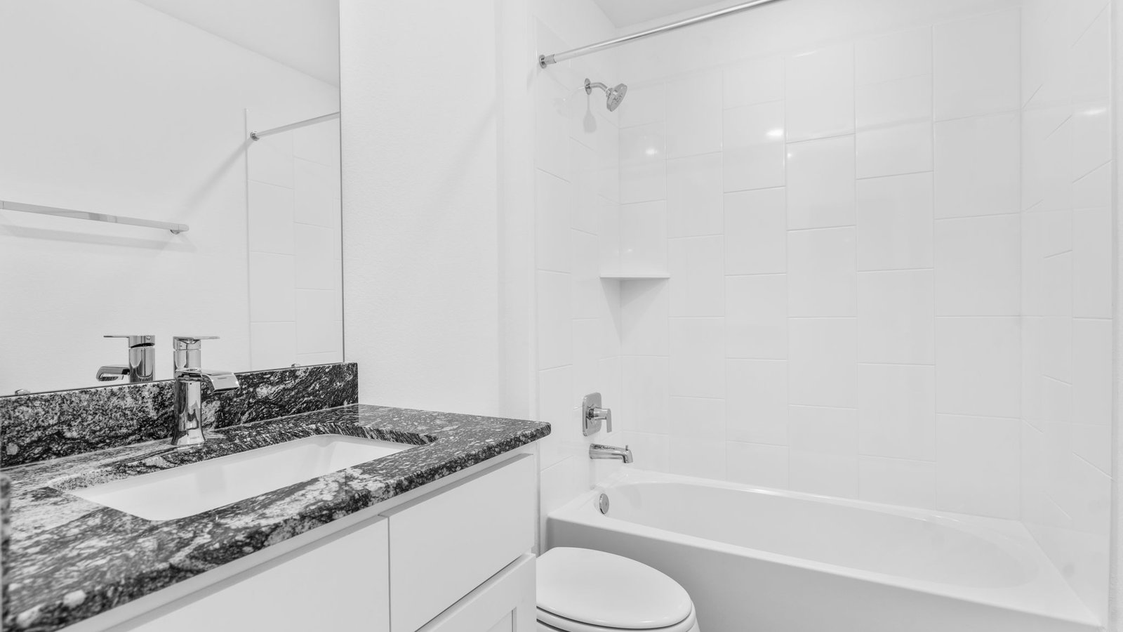 A well-designed bathroom equipped with quartz countertops, a standing tub, and a single vanity.