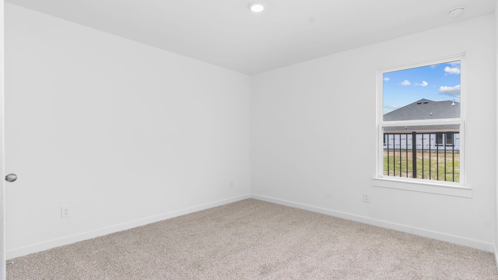 A second bedroom with carpet flooring and a separate closet.