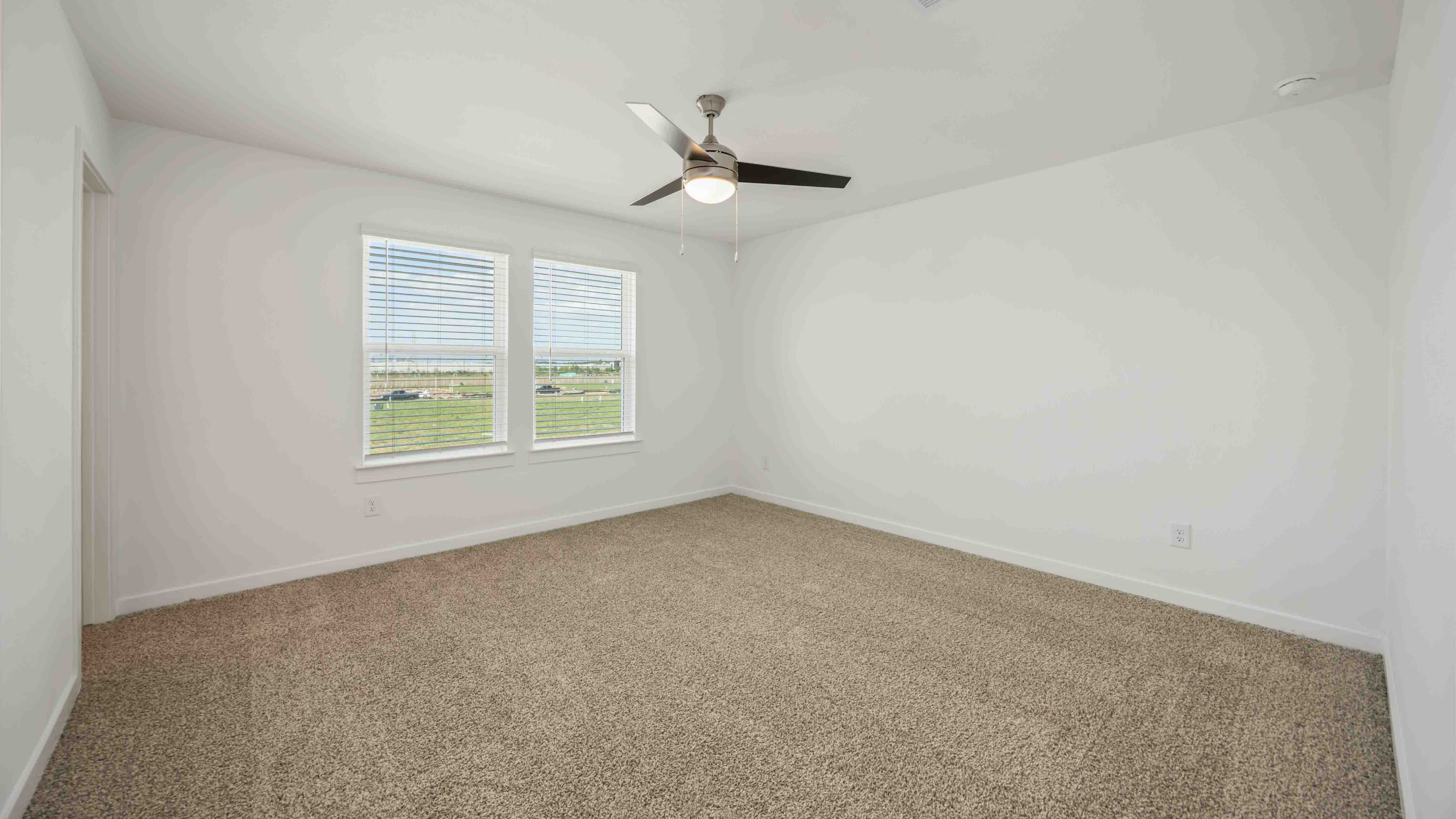 a spacious primary suite comfortably fits a king size bed and additional bedroom furniture