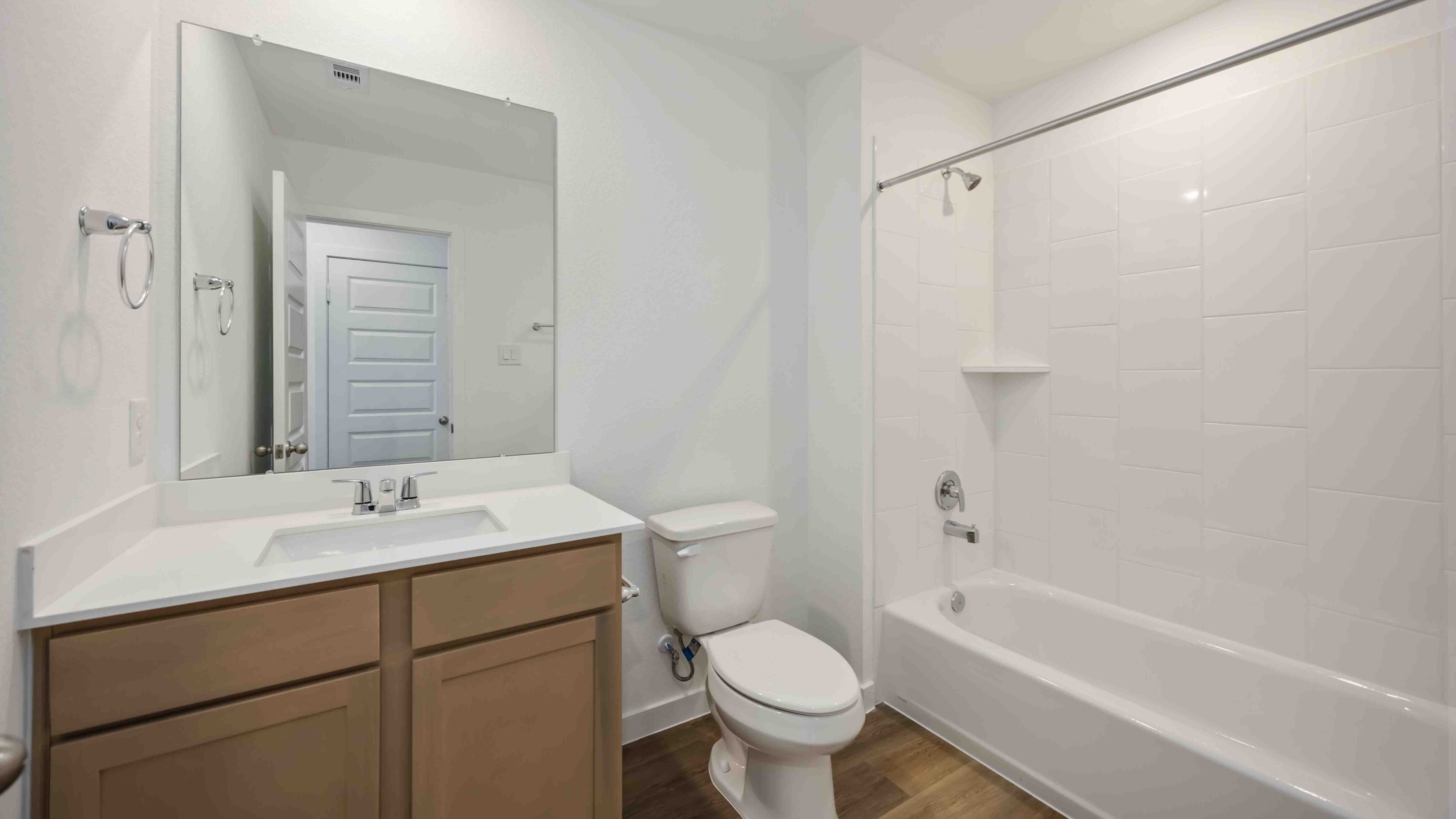 a spacious secondary bathroom with one sink vanity and standing tub
