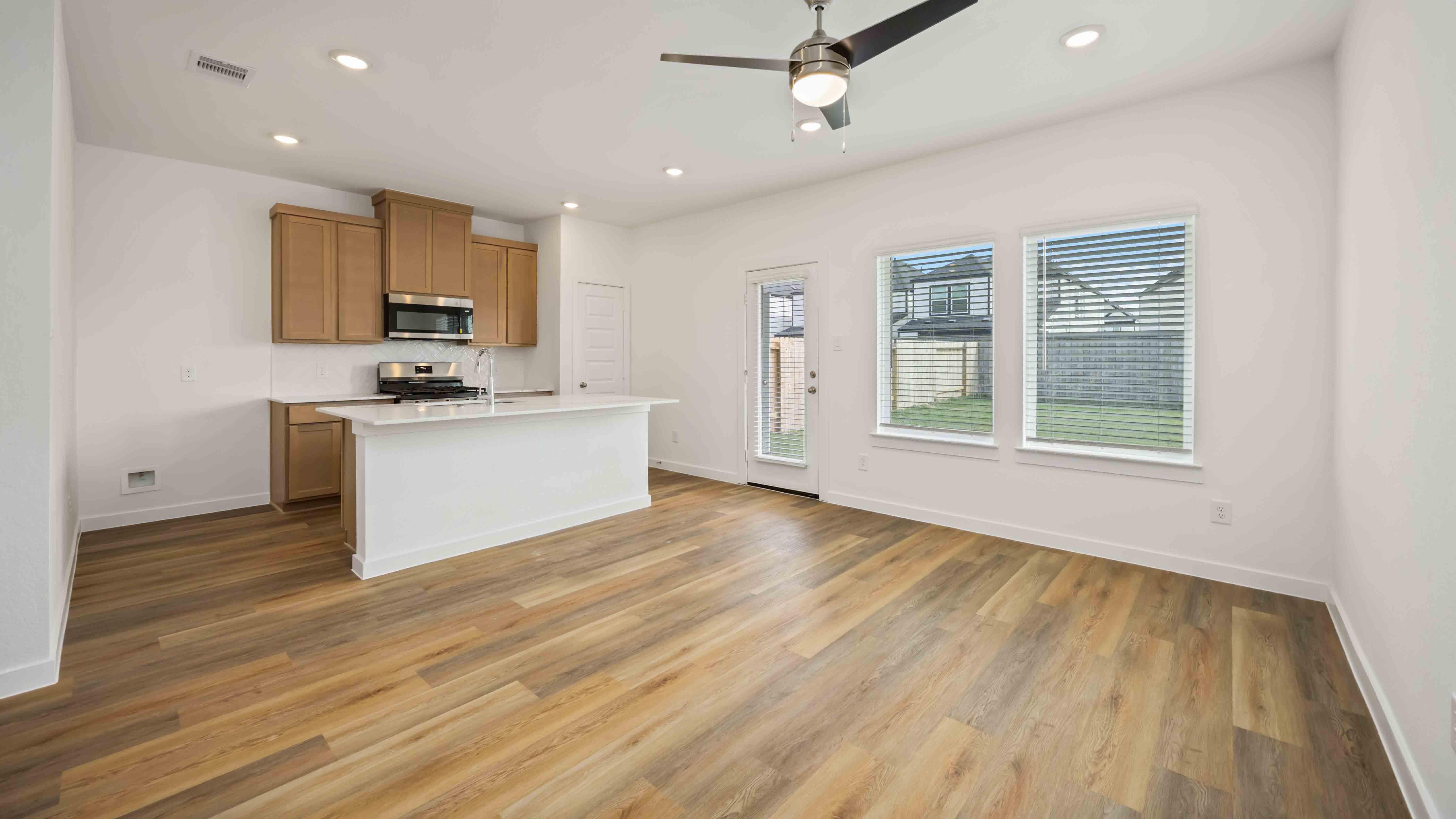 beautiful new kitchen with quartz counter tops, wood cabinets, and herringbone backsplash