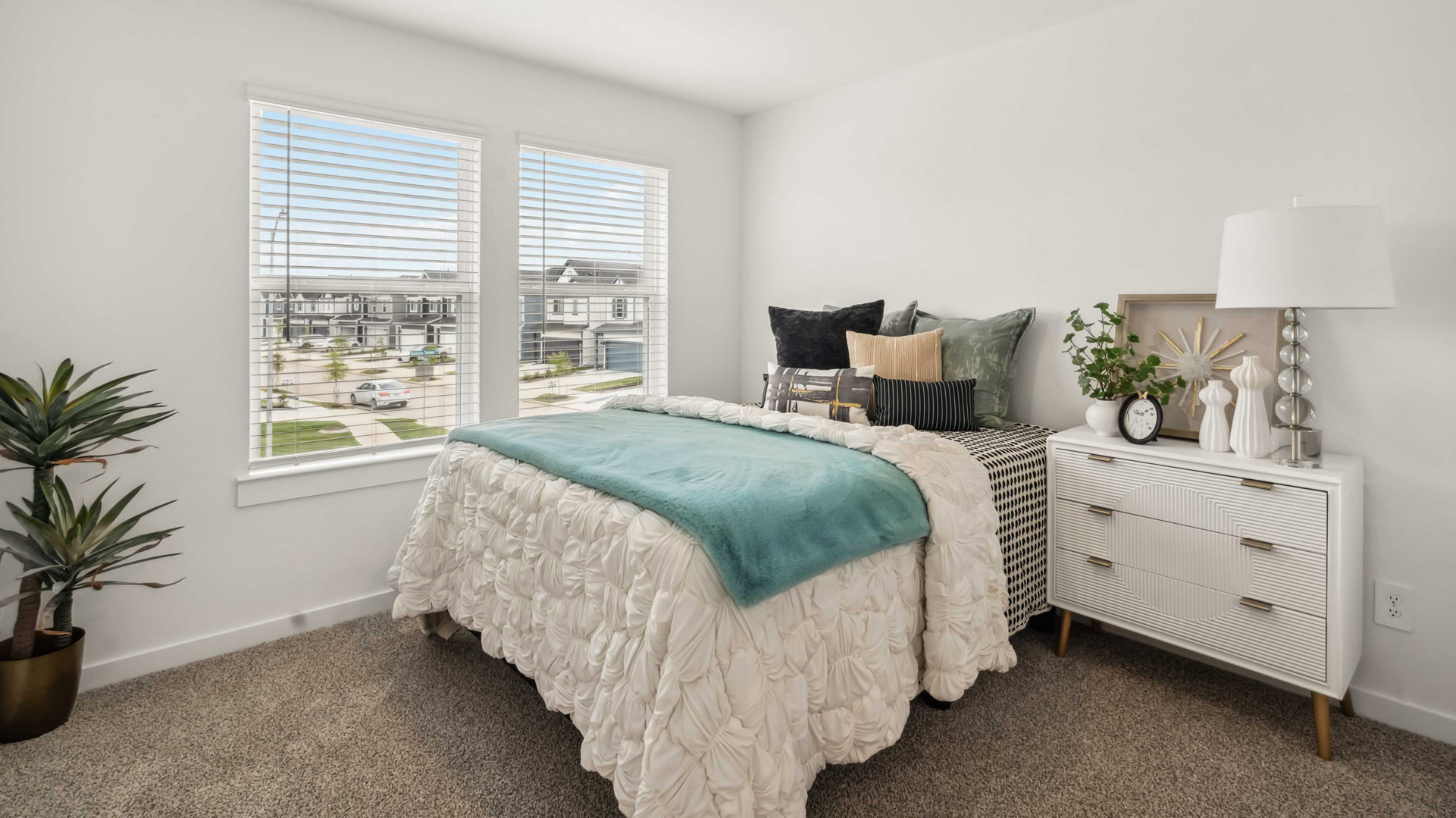 secondary bedrooms have light neutral walls and carpet flooring