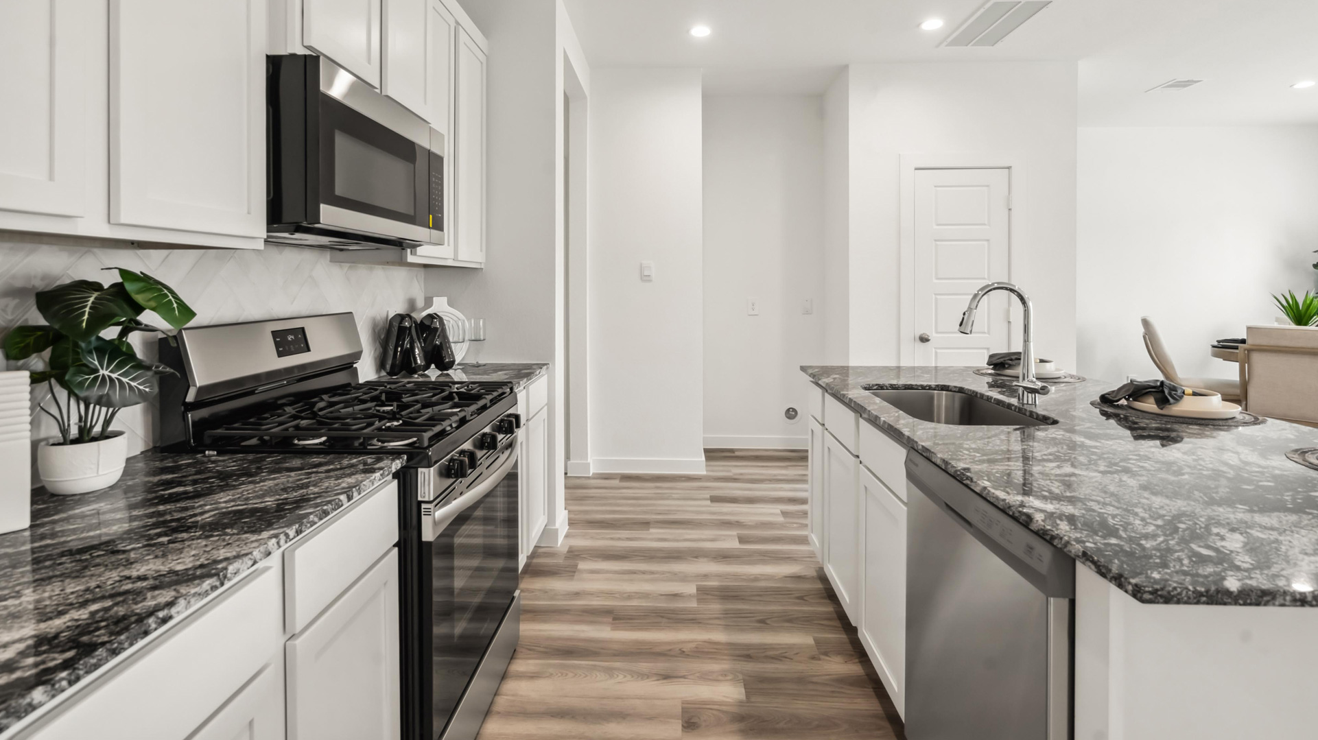 beautiful new kitchen with quartz counter tops, wood cabinets, and herringbone backsplash