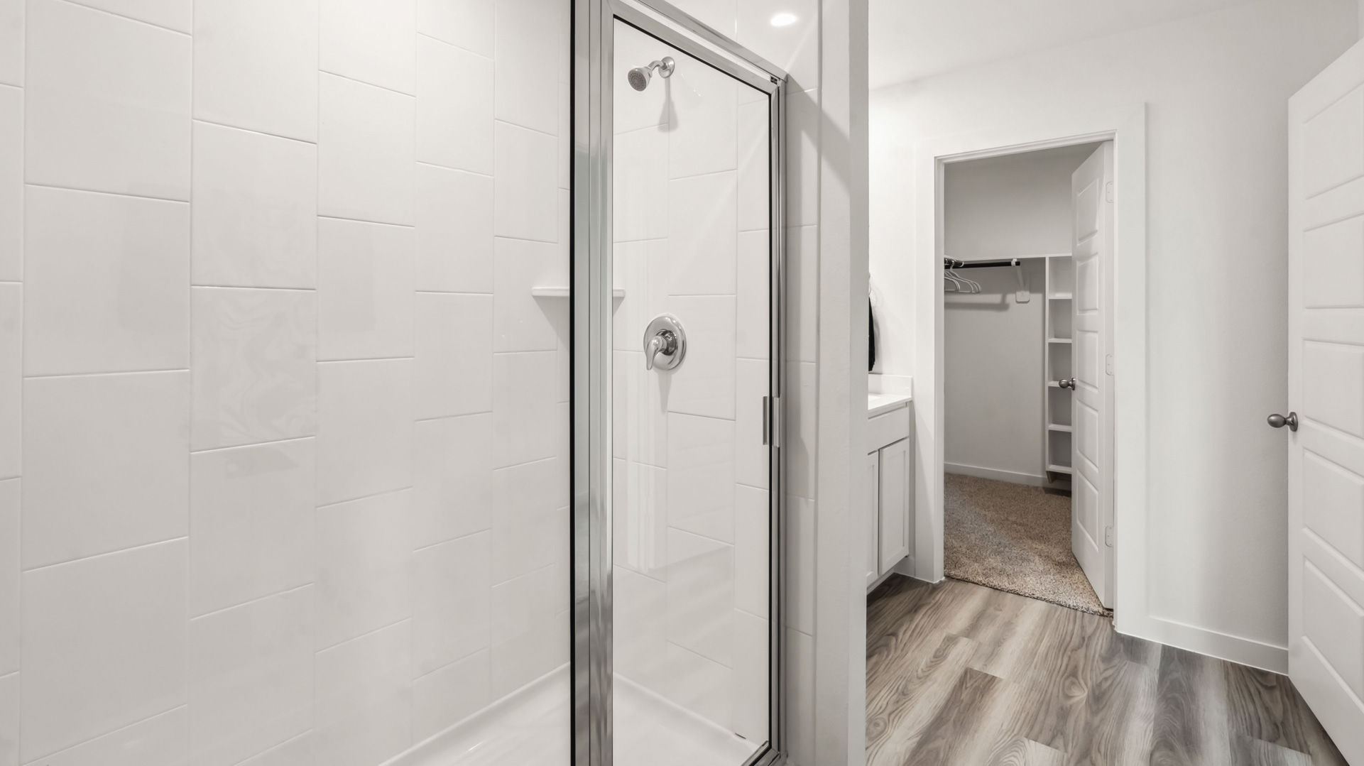 the primary bathroom with a window and a standing shower