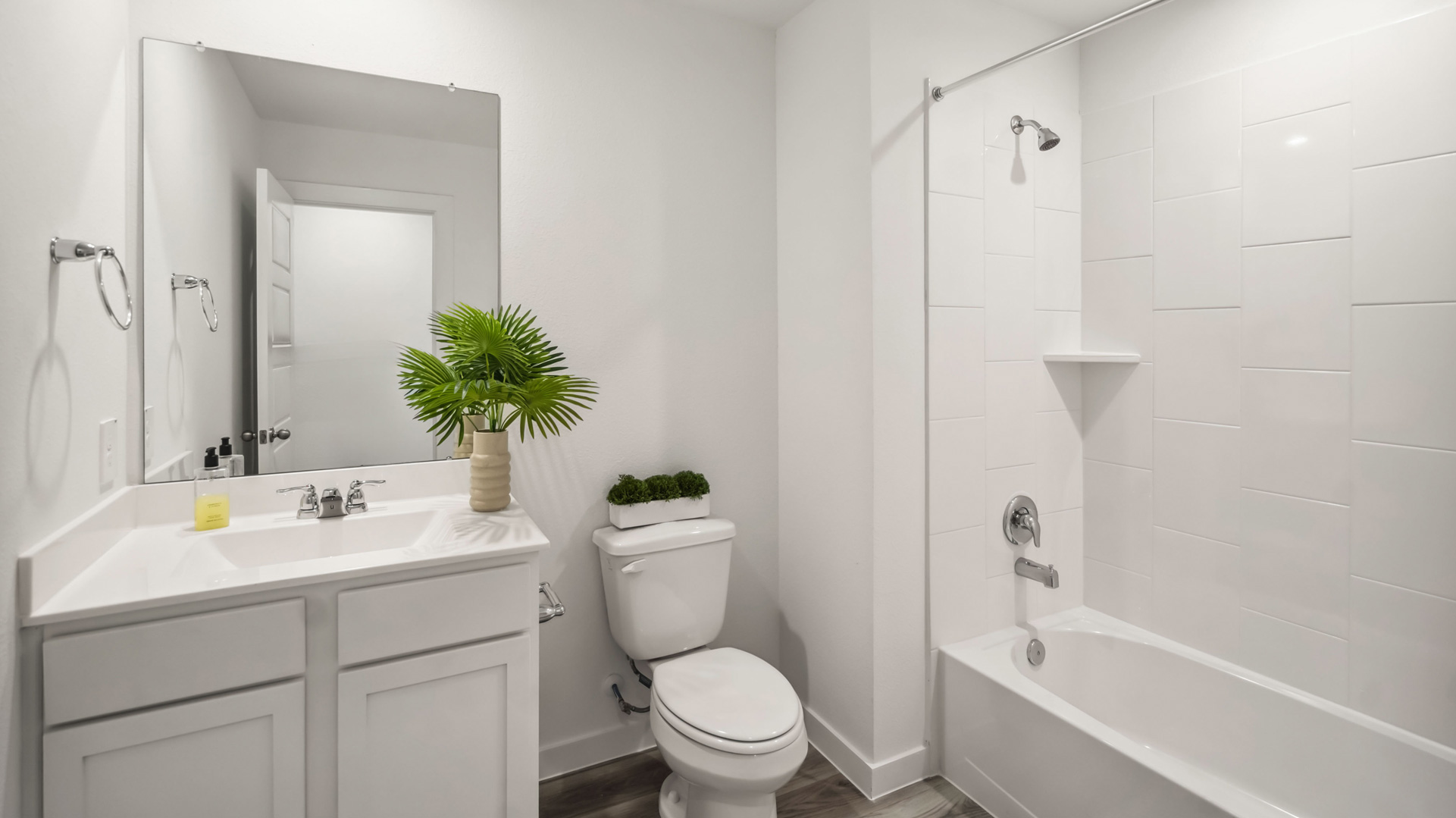 a spacious secondary bathroom with one sink vanity and standing tub