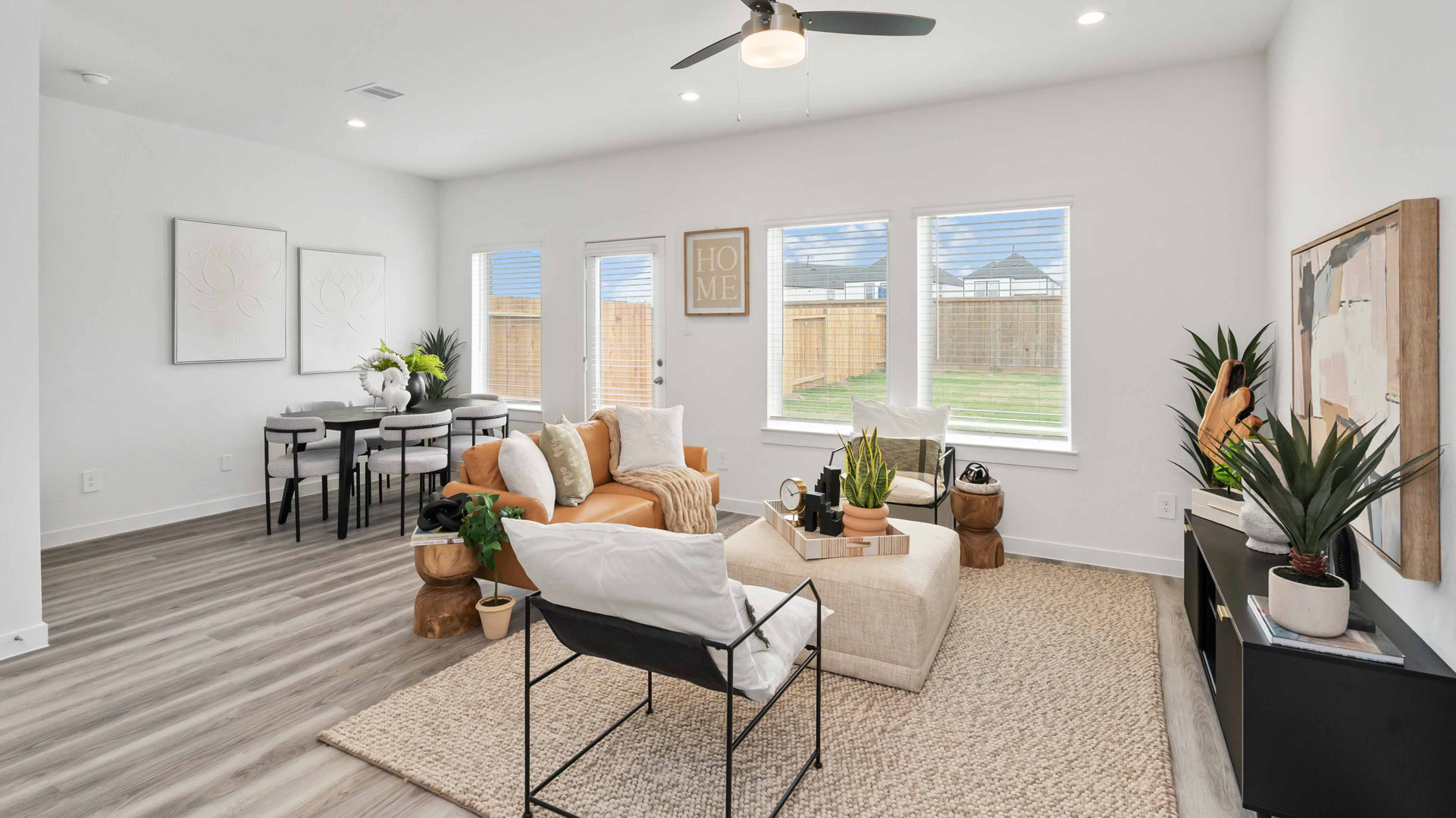 spacious living room with plenty of natural light from windows overlooking the backyard