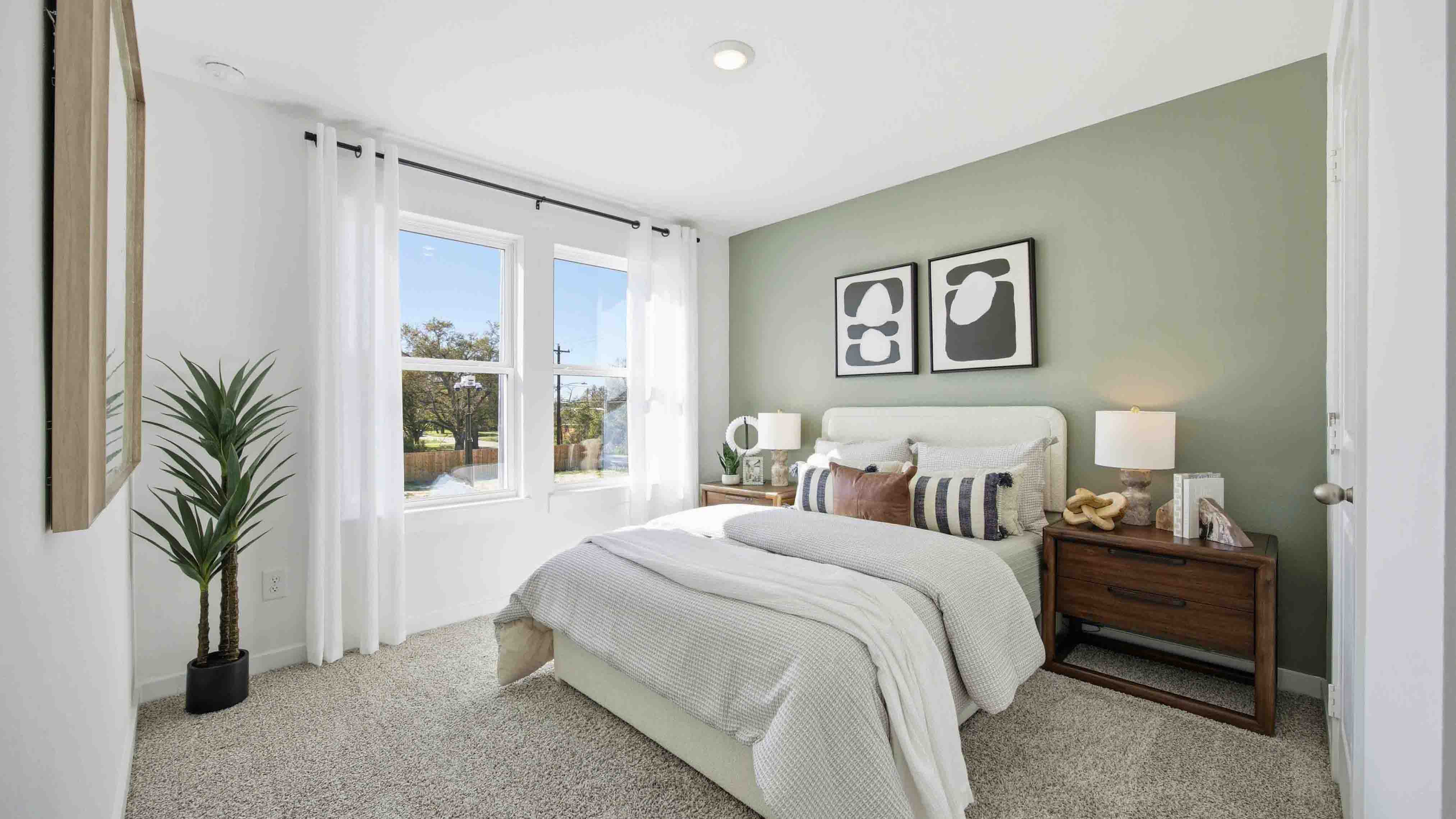 secondary bedrooms have light neutral walls and carpet flooring