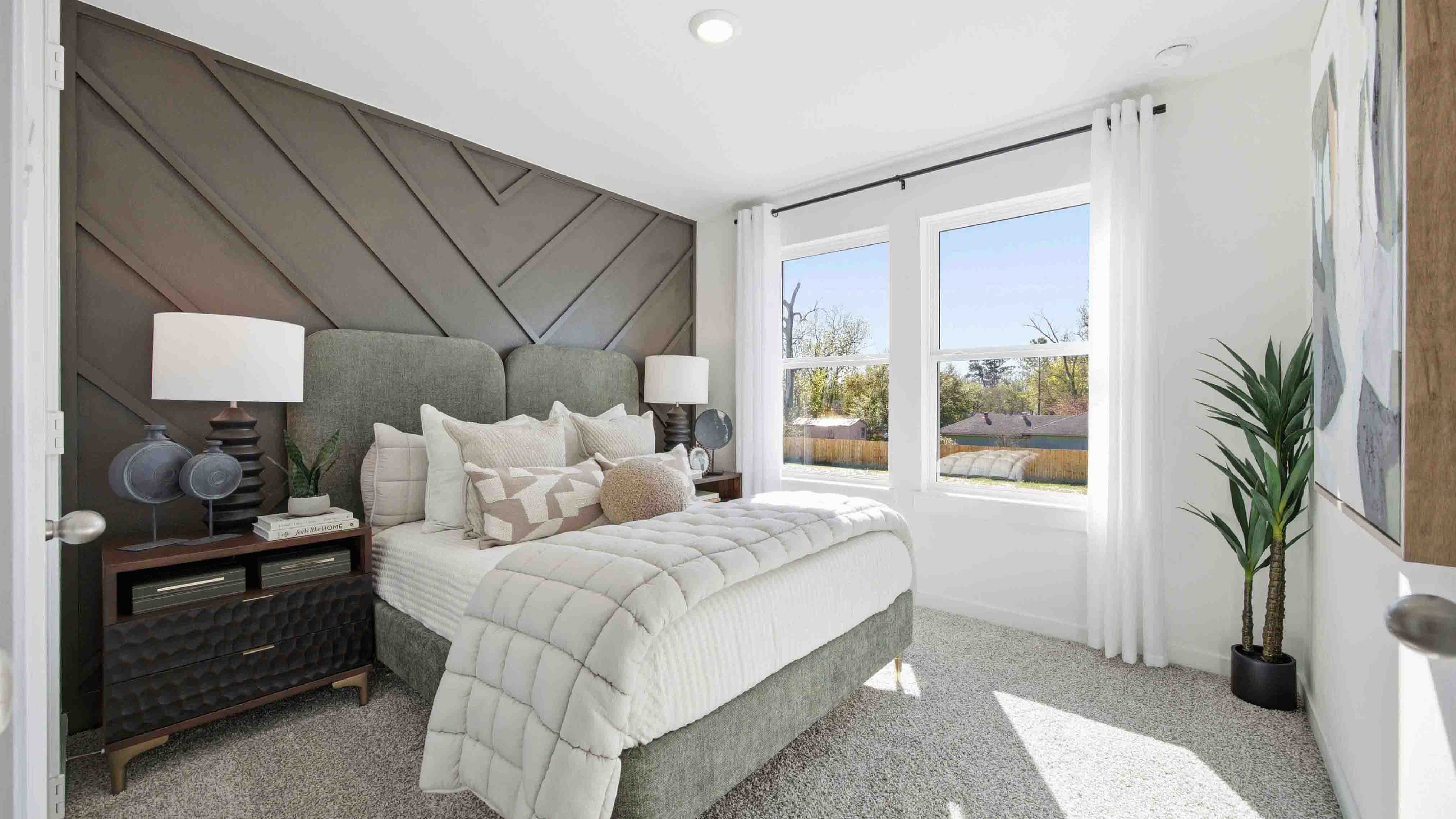 third bedroom has light neutral walls and carpet flooring