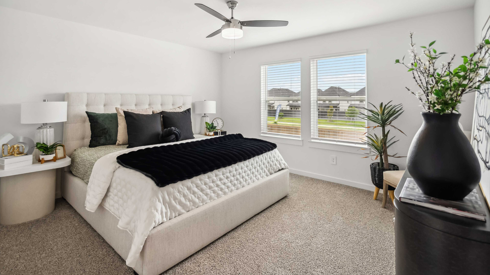 a spacious primary suite comfortably fits a king size bed and additional bedroom furniture