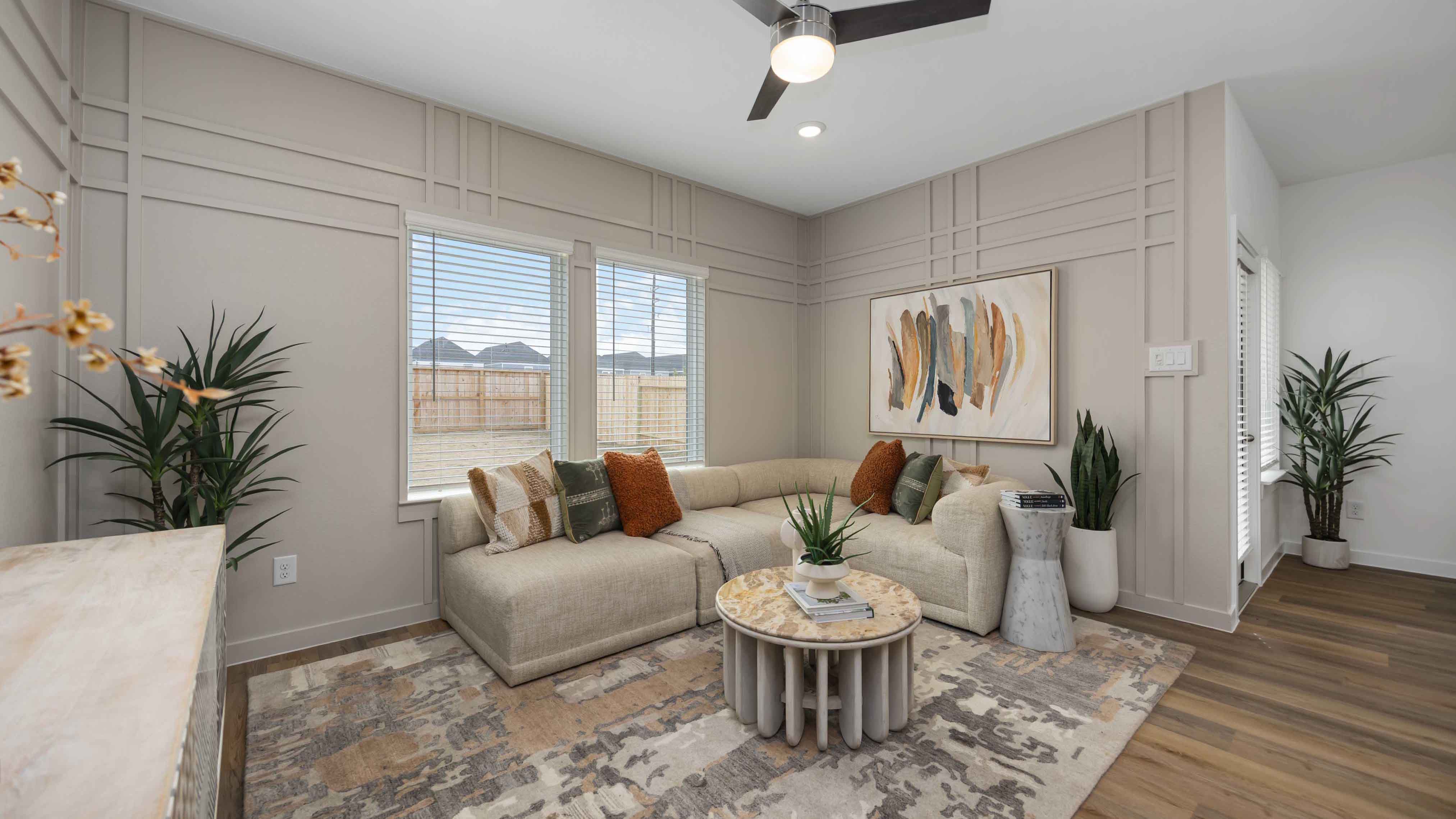 living room area with two large windows to the backyard