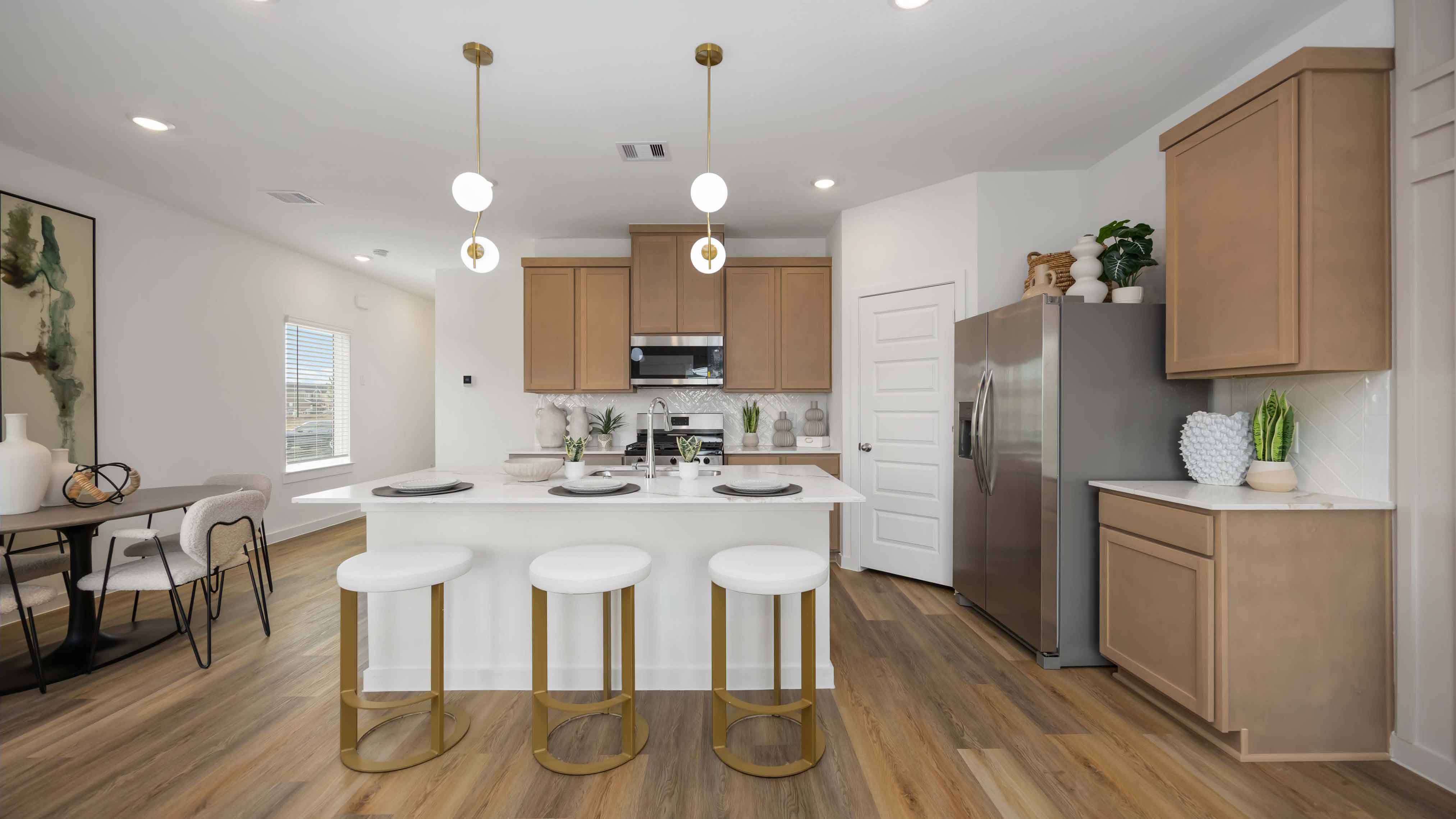 beautiful new kitchen with quartz counter tops, wood cabinets, and herringbone backsplash
