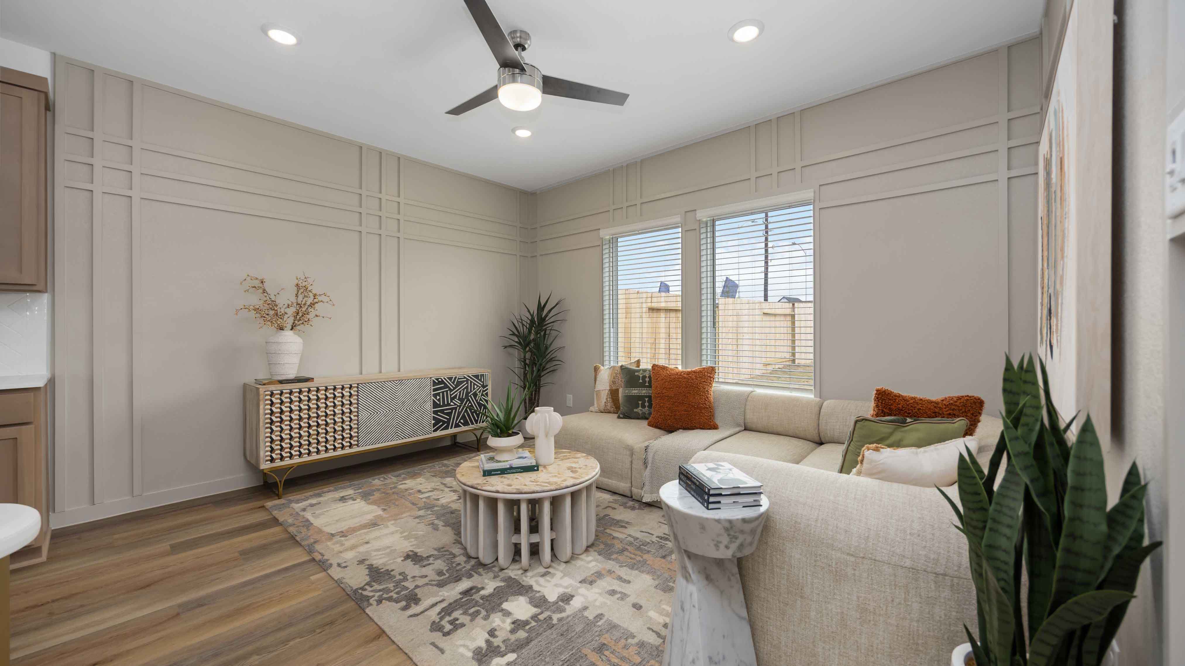 spacious living room with plenty of natural light from windows overlooking the backyard