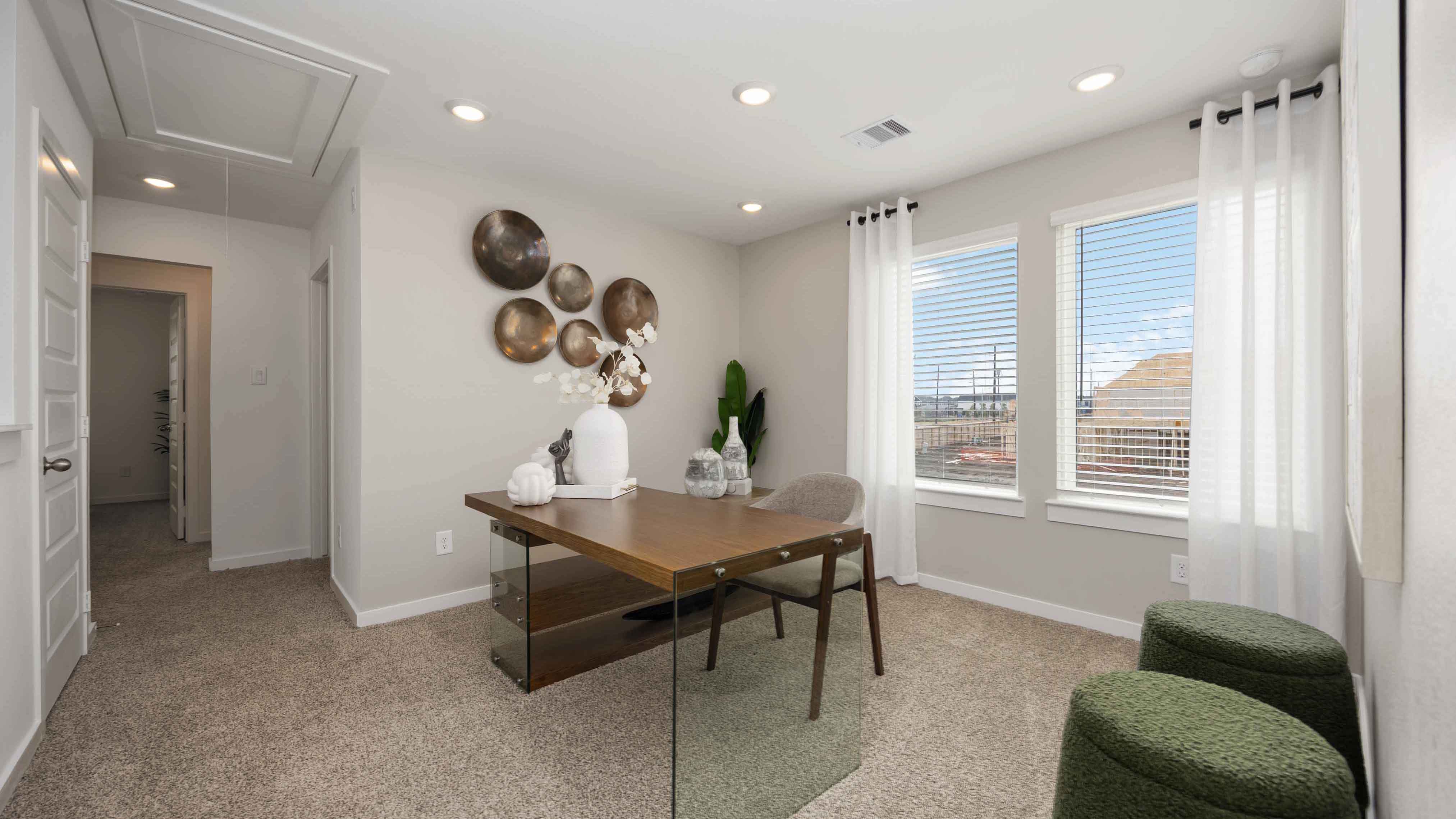 spacious upstairs living area with plenty of natural light from windows overlooking side of the home