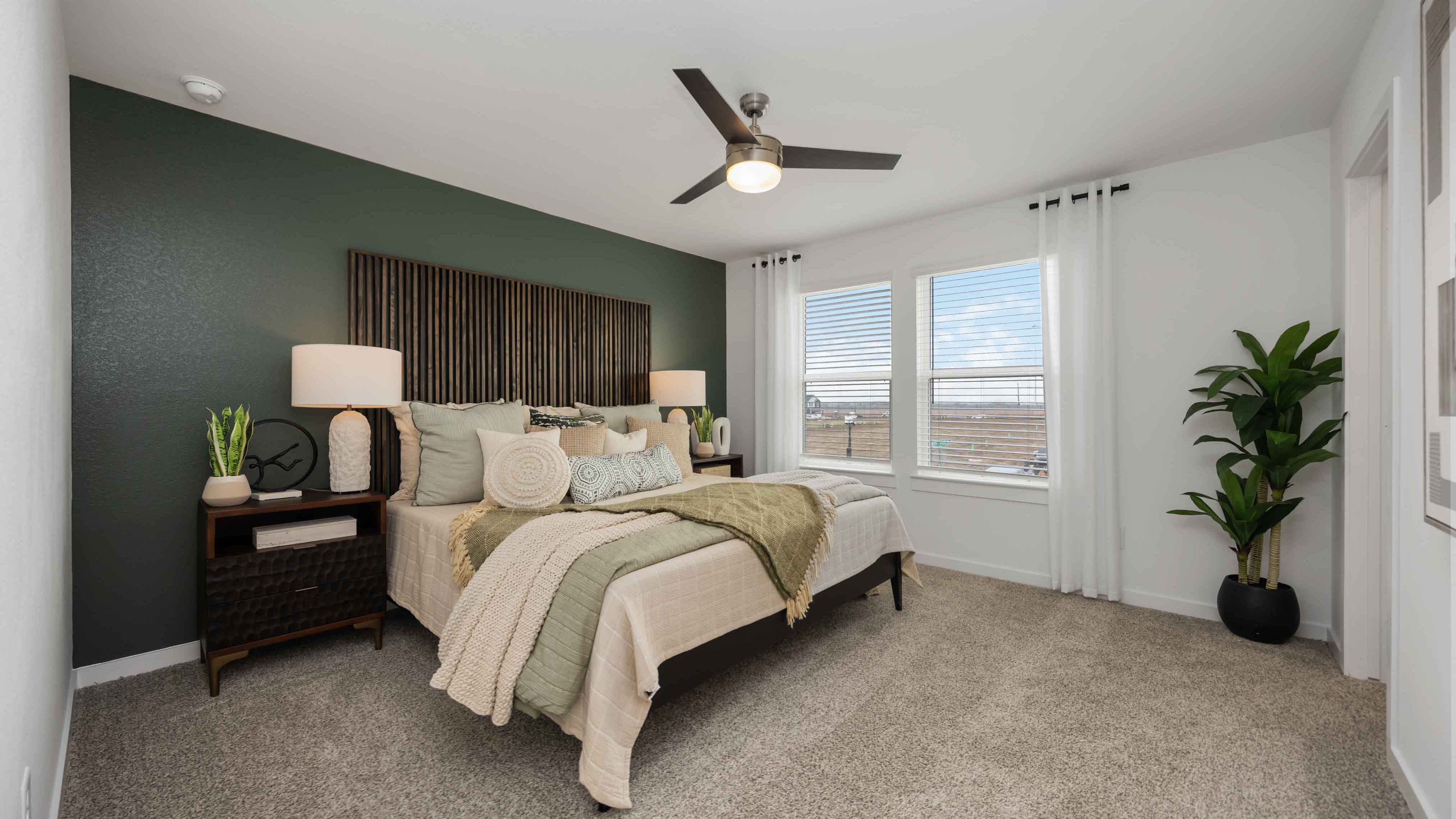 a spacious primary suite comfortably fits a king size bed and additional bedroom furniture