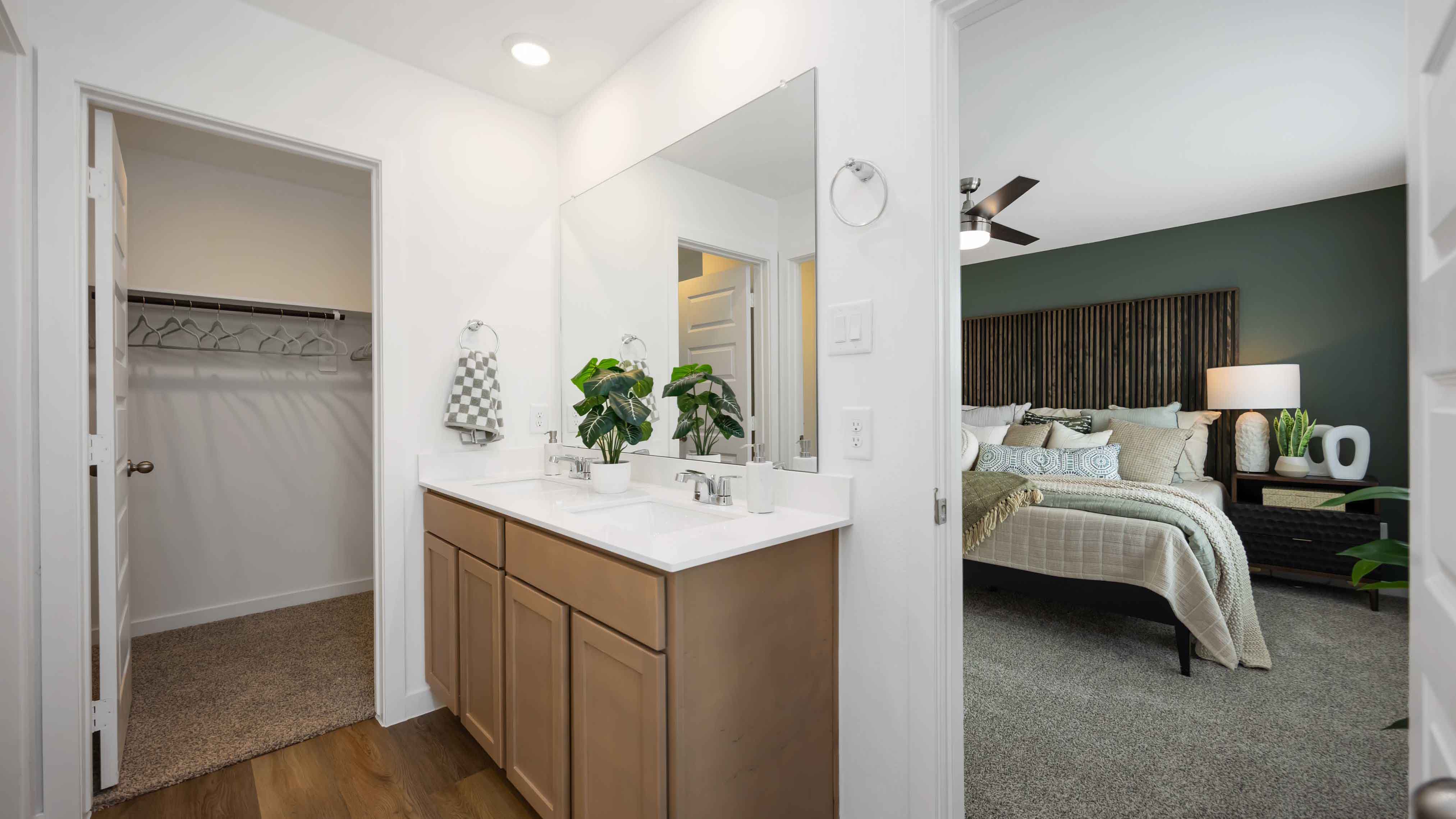 the en-suite primary bathroom has a double vanity and a standing shower