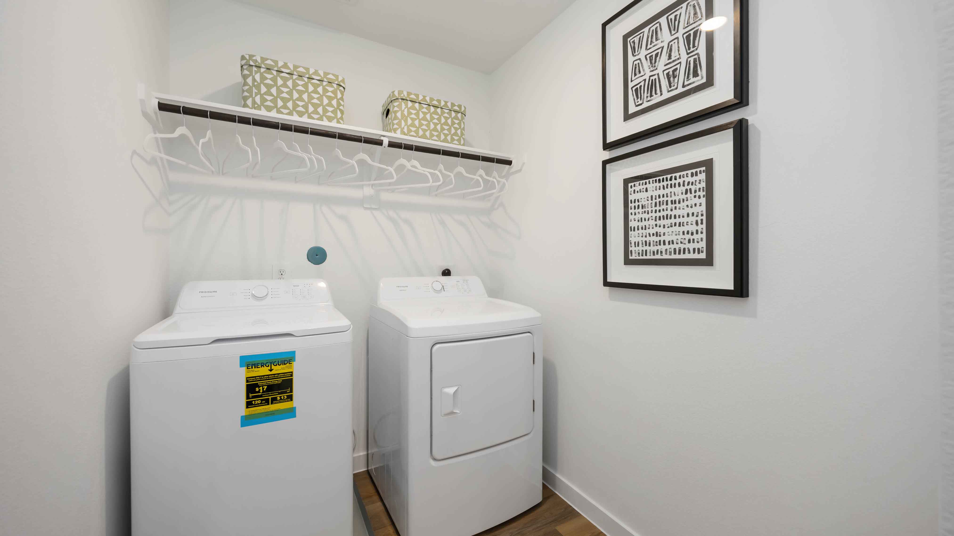 laundry room area with an open shelf and rod for additional storage and hanging clothes