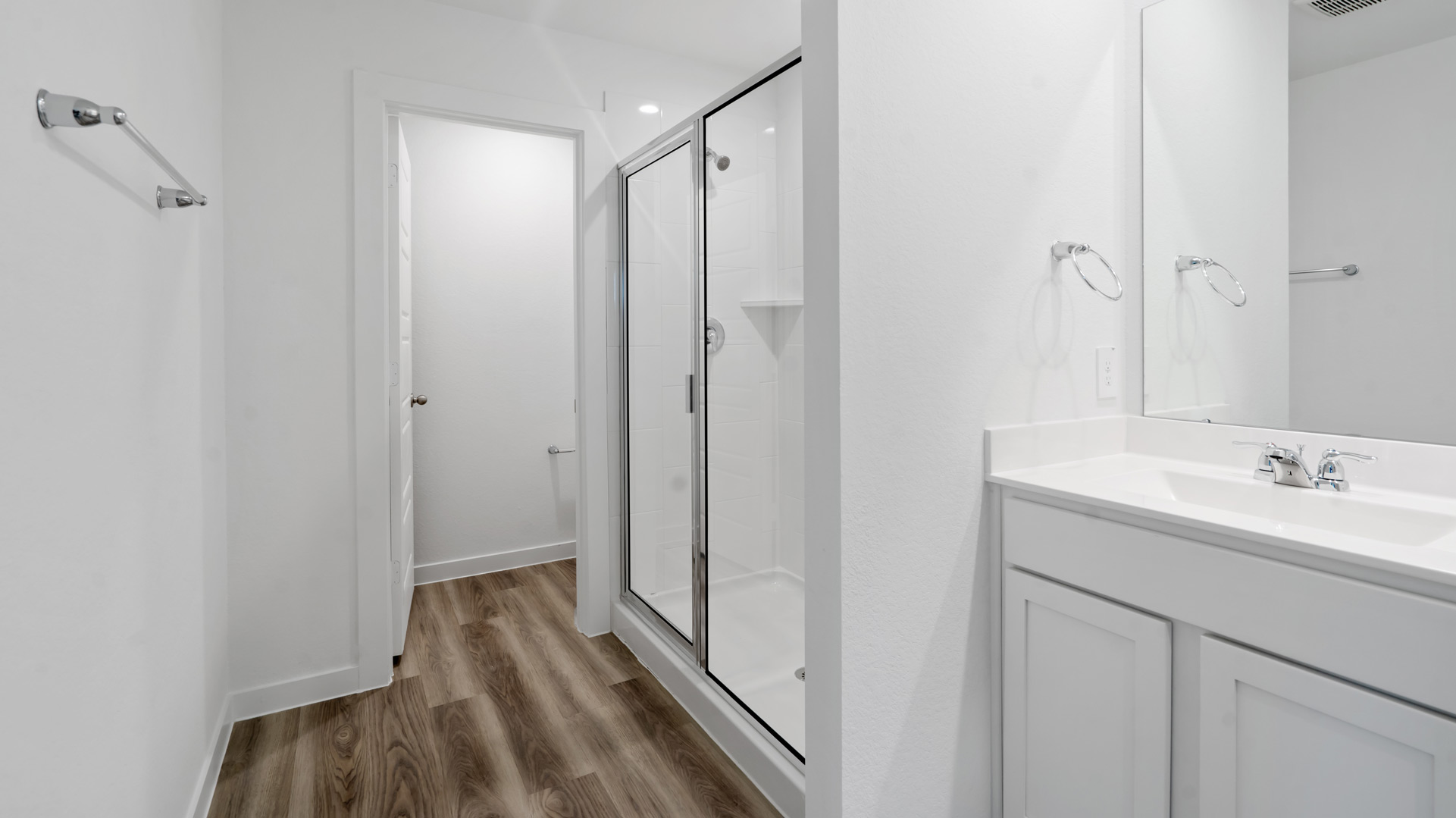 the en-suite primary bathroom has a double vanity and spacious walk-in closet