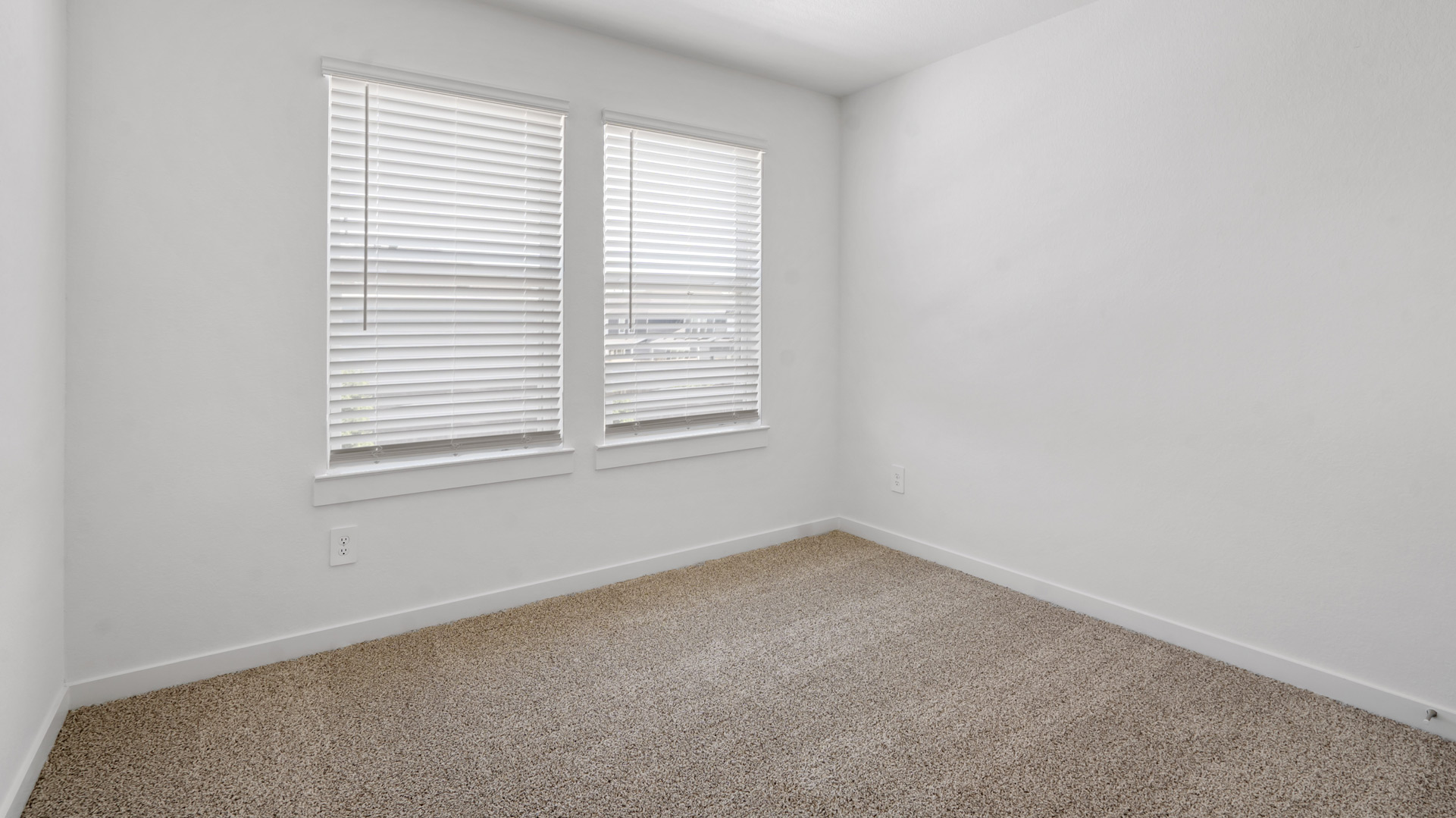 a spacious primary suite comfortably fits a king size bed and additional bedroom furniture