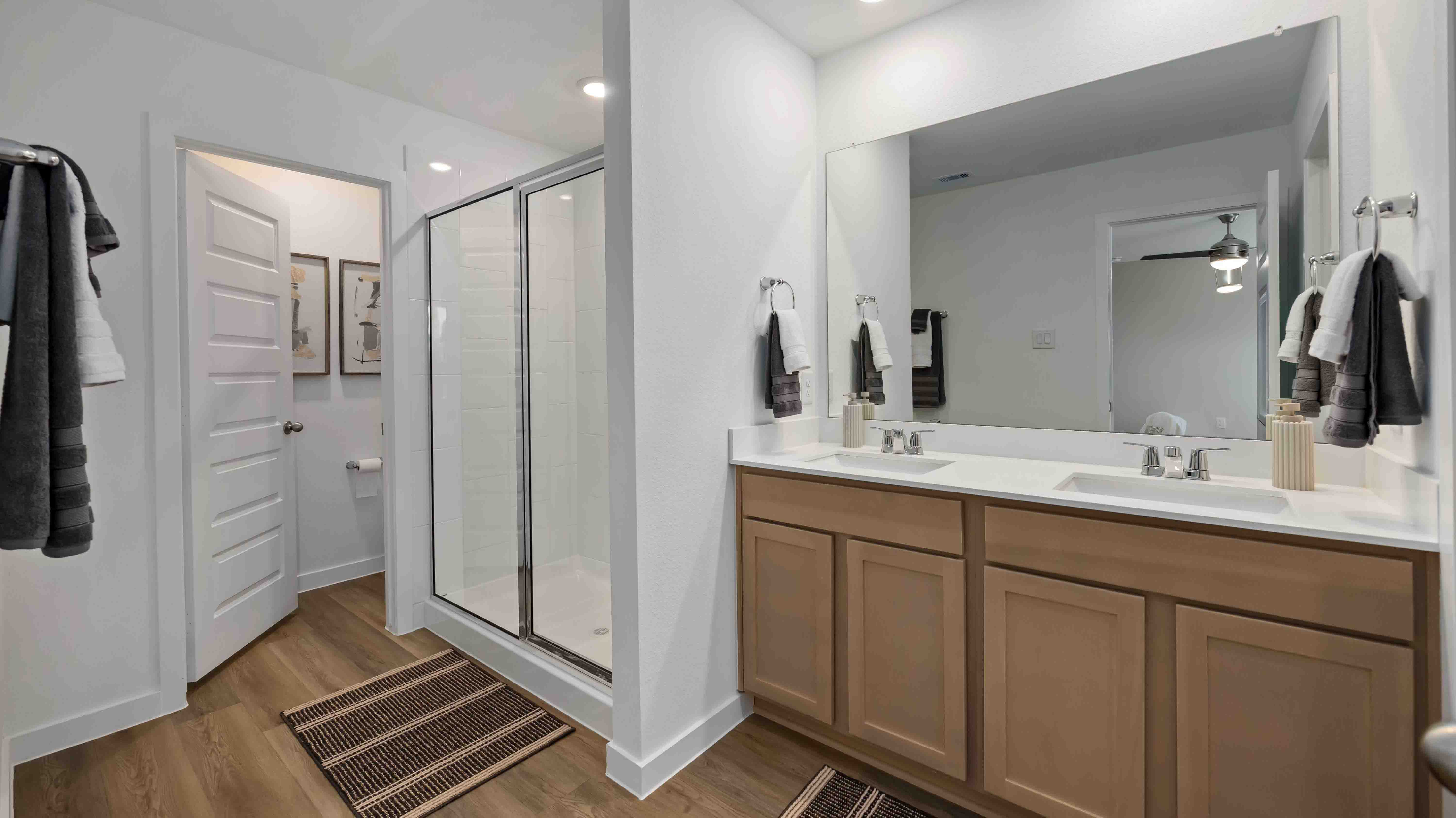 the en-suite primary bathroom has a double vanity and spacious walk-in closet