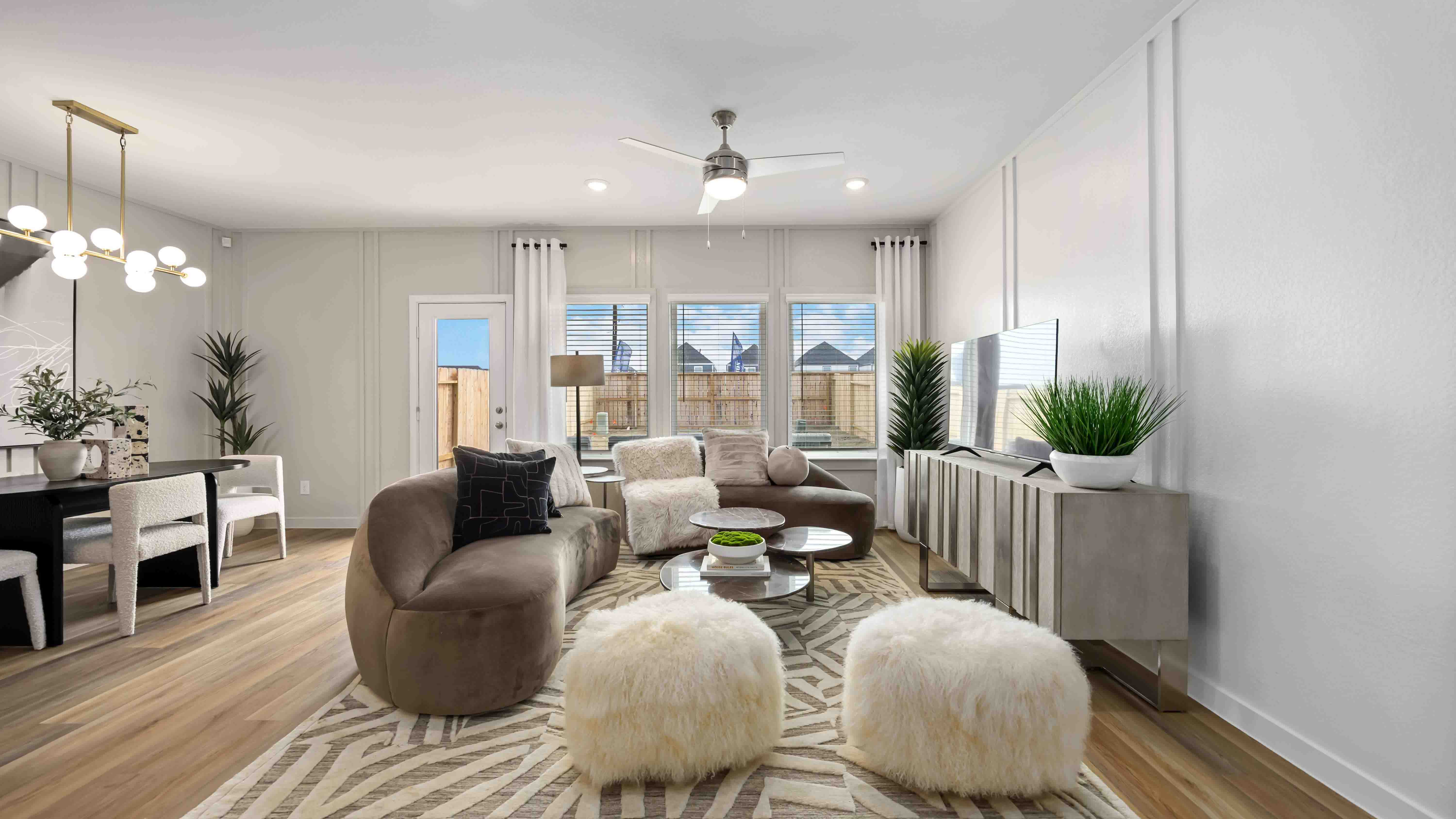 spacious living room with plenty of natural light from windows overlooking the backyard