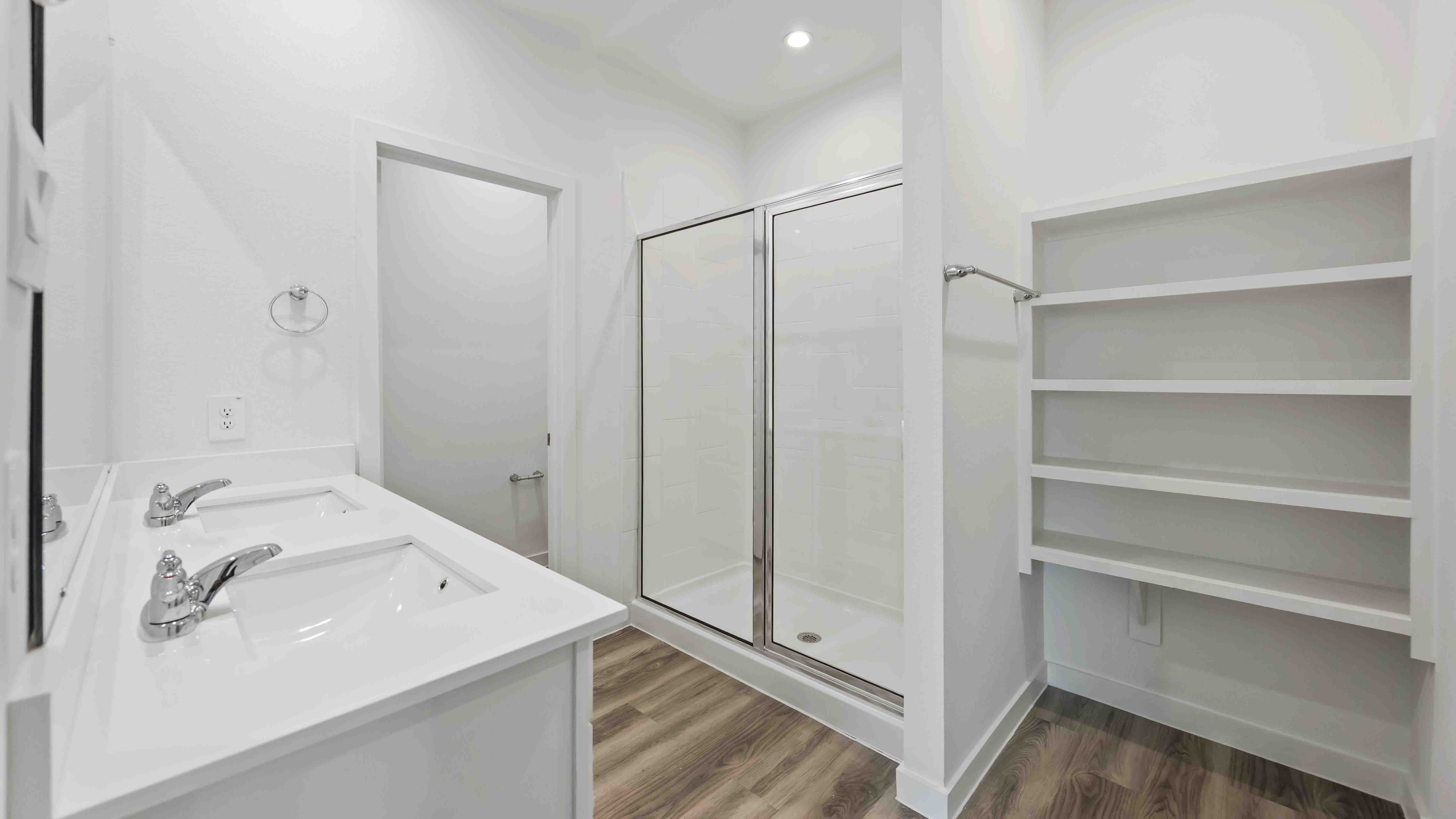 the en-suite primary bathroom has a double vanity and spacious walk-in closet