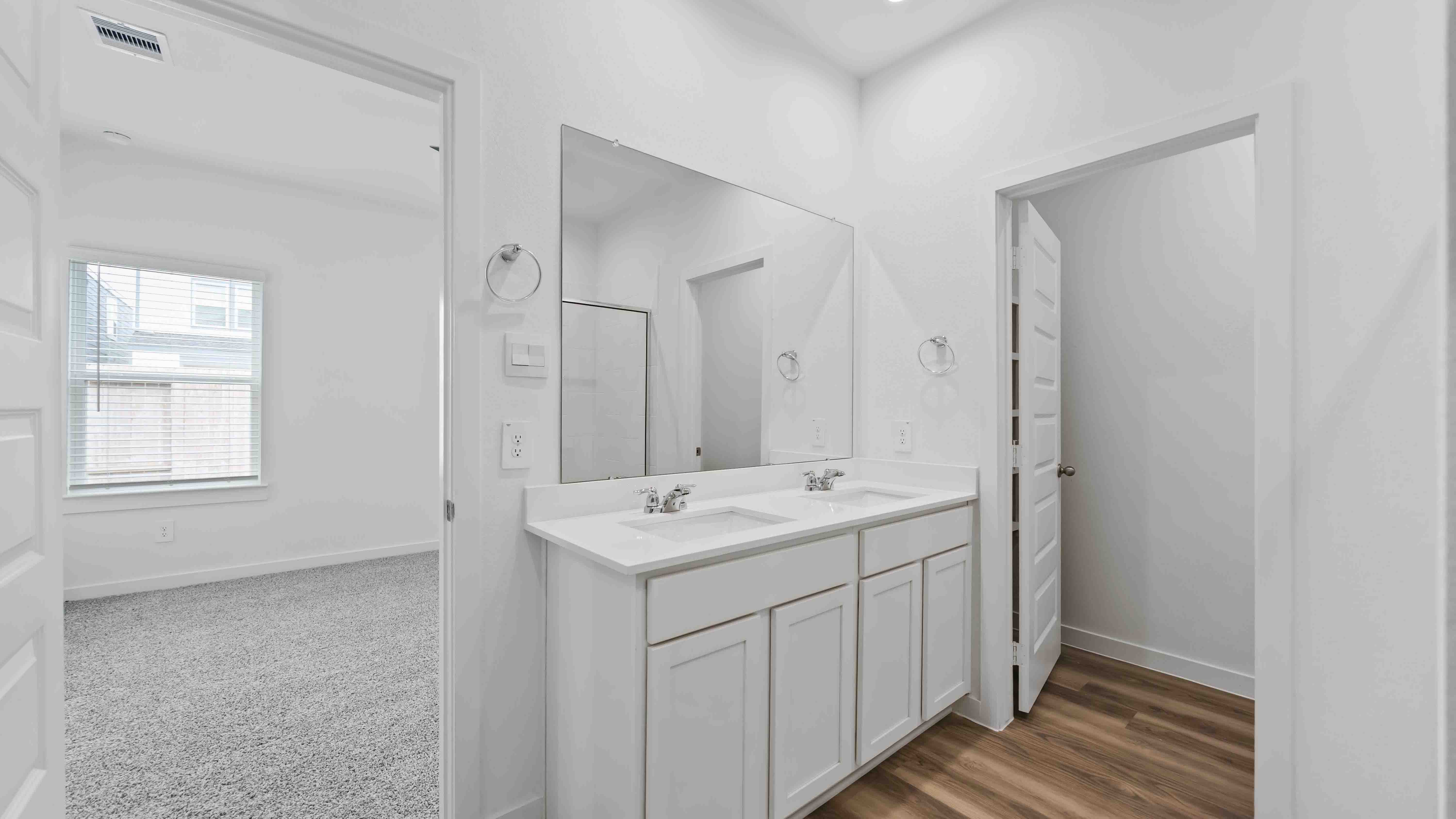 the primary bathroom with a window and a standing shower