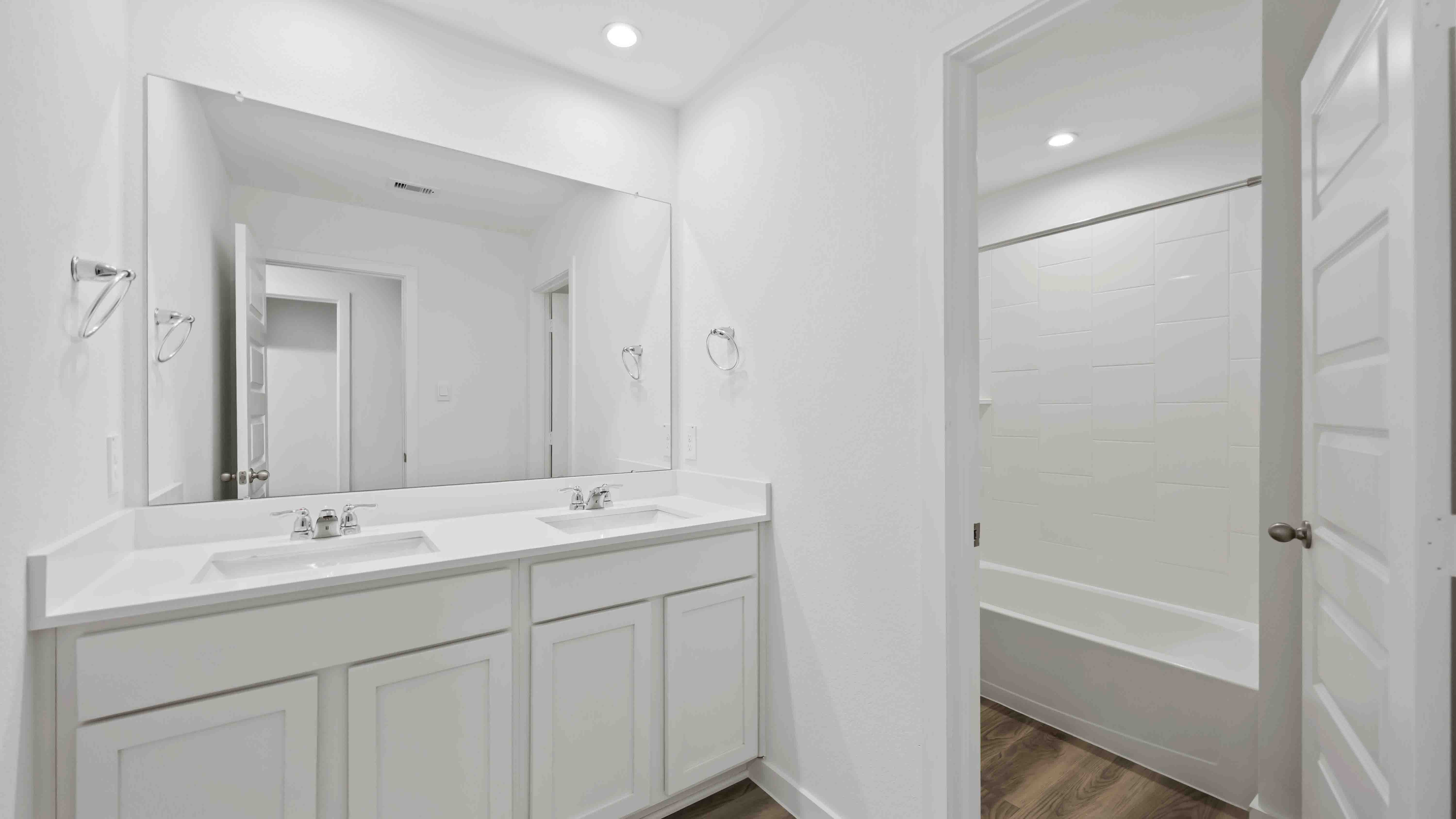 a spacious secondary bathroom with one sink vanity and standing tub