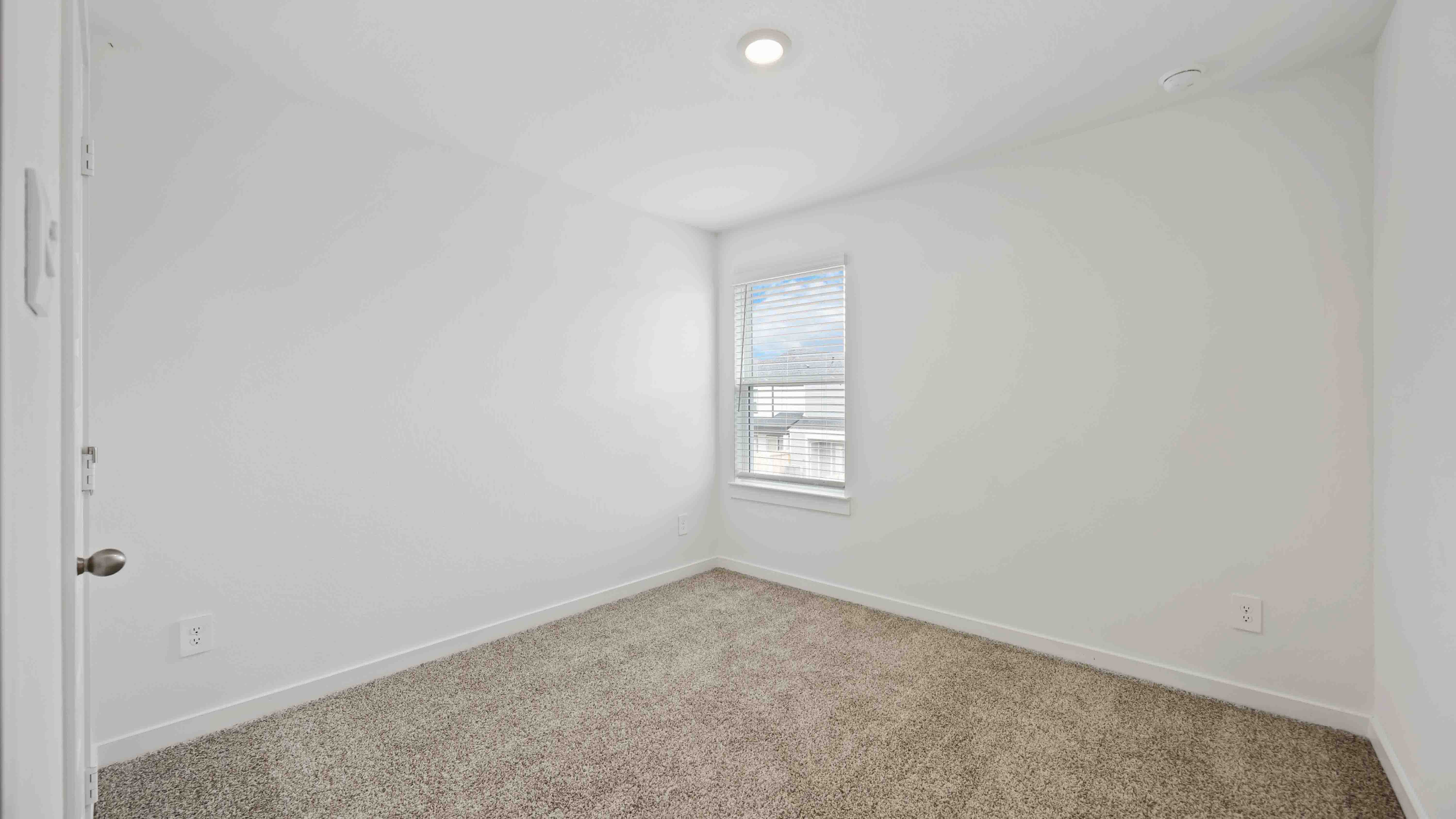 fourth bedroom with a large window for natural lighting