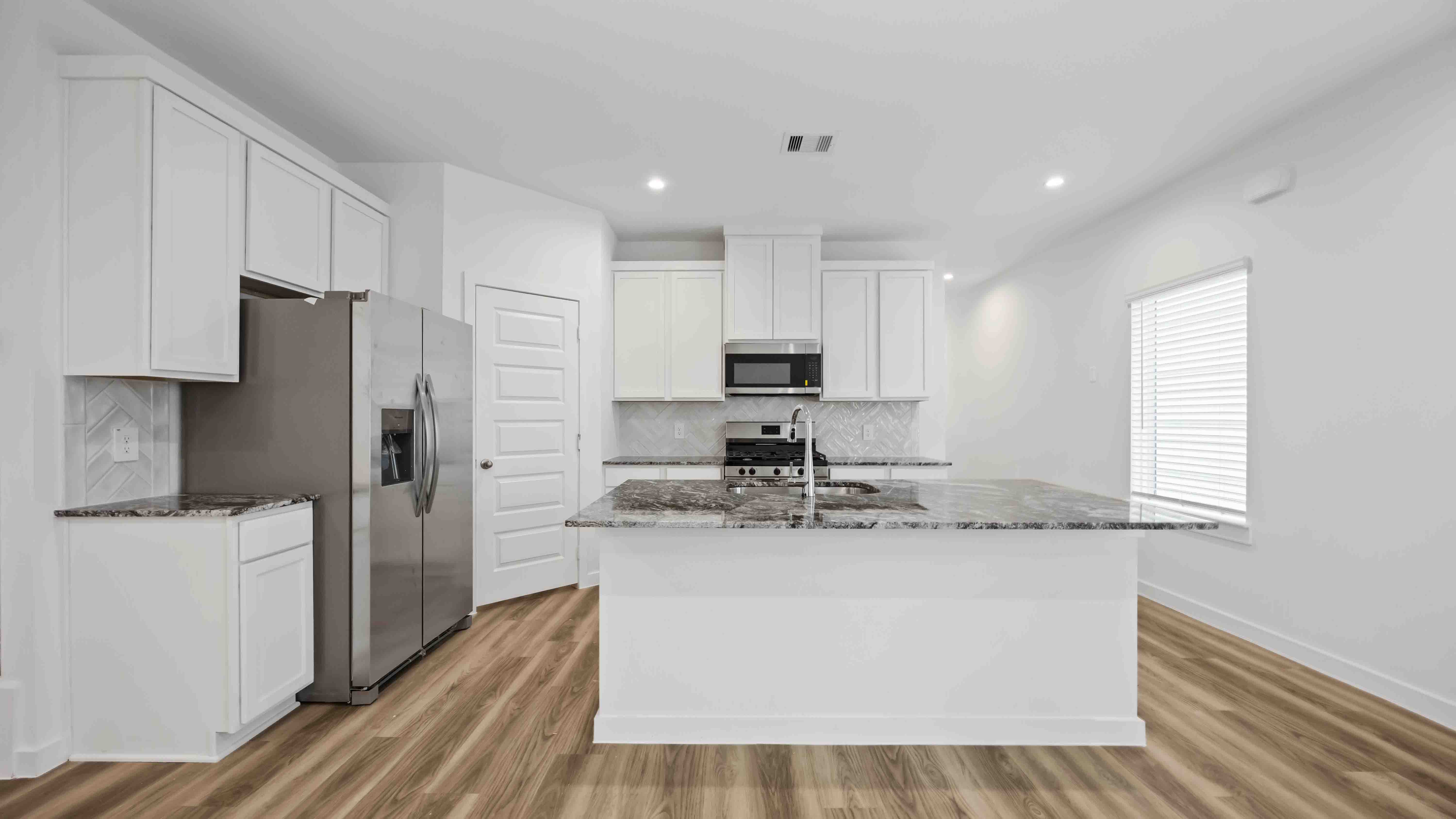 kitchen island - a spacious island offers bar seating perfect for dining or entertaining