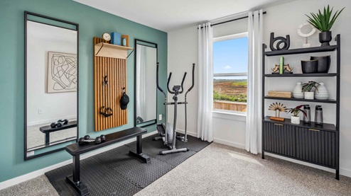 third bedroom shown as a home gym, with a single window overlooking the backyard