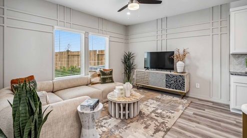 living room of the Iris model, with large windows overlooking the backyard