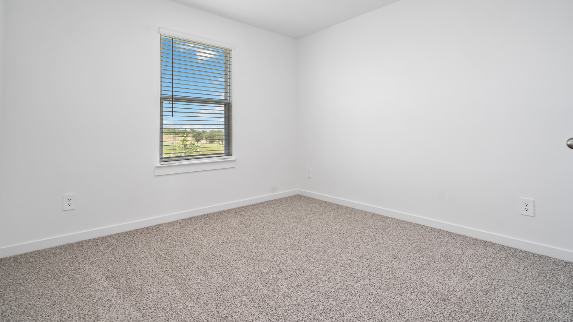 second bedroom with large single window for natural light