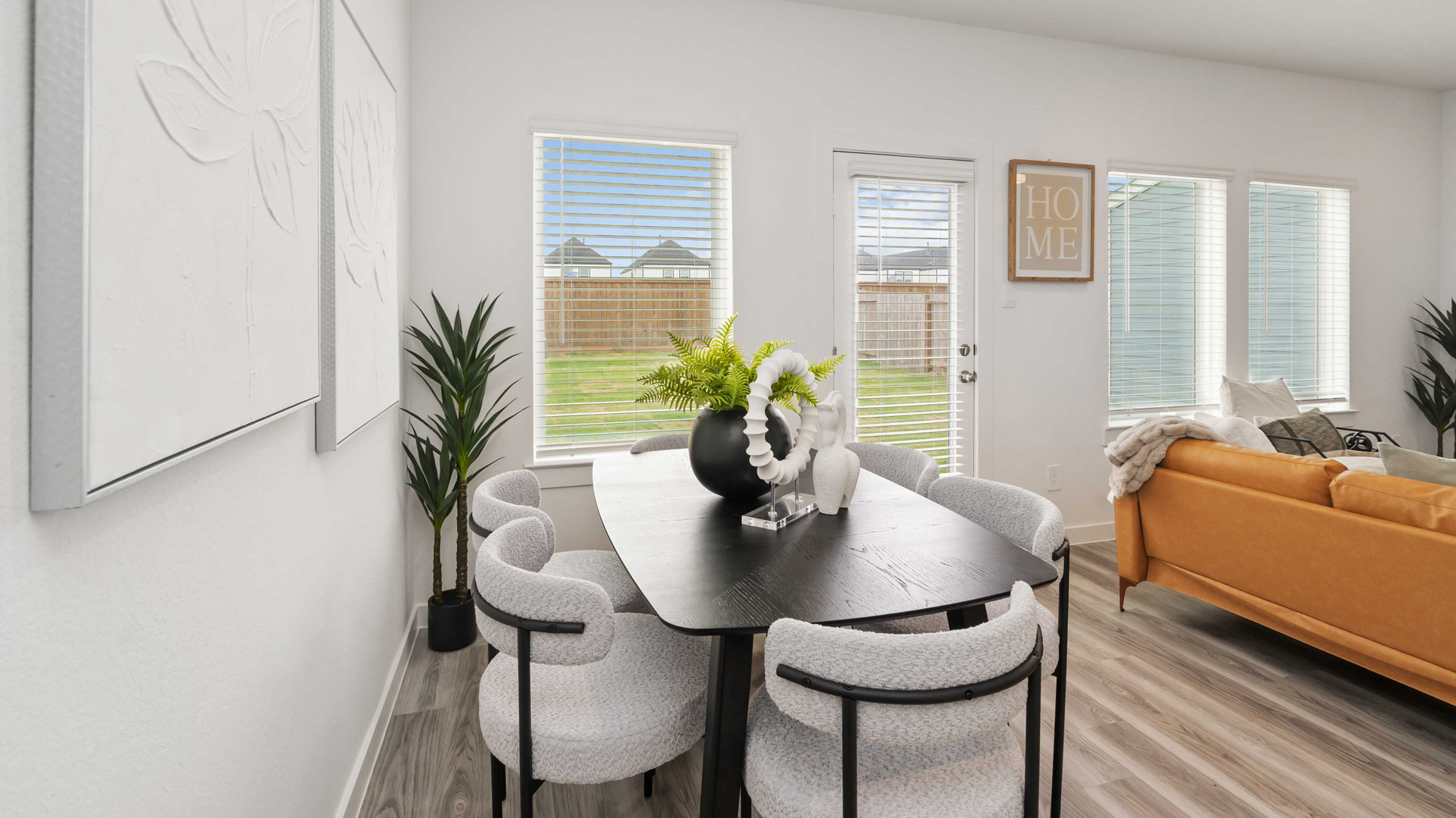 dining and living room both overlook the backyard and have abundant windows for natural light