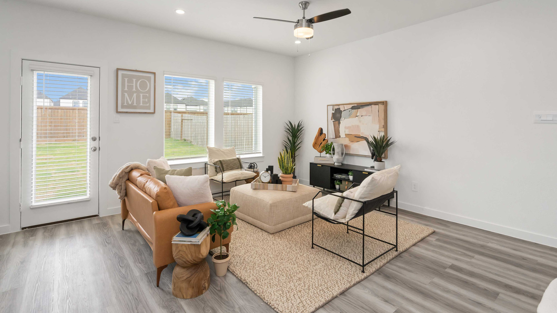 spacious living room with plenty of natural light from windows overlooking the backyard