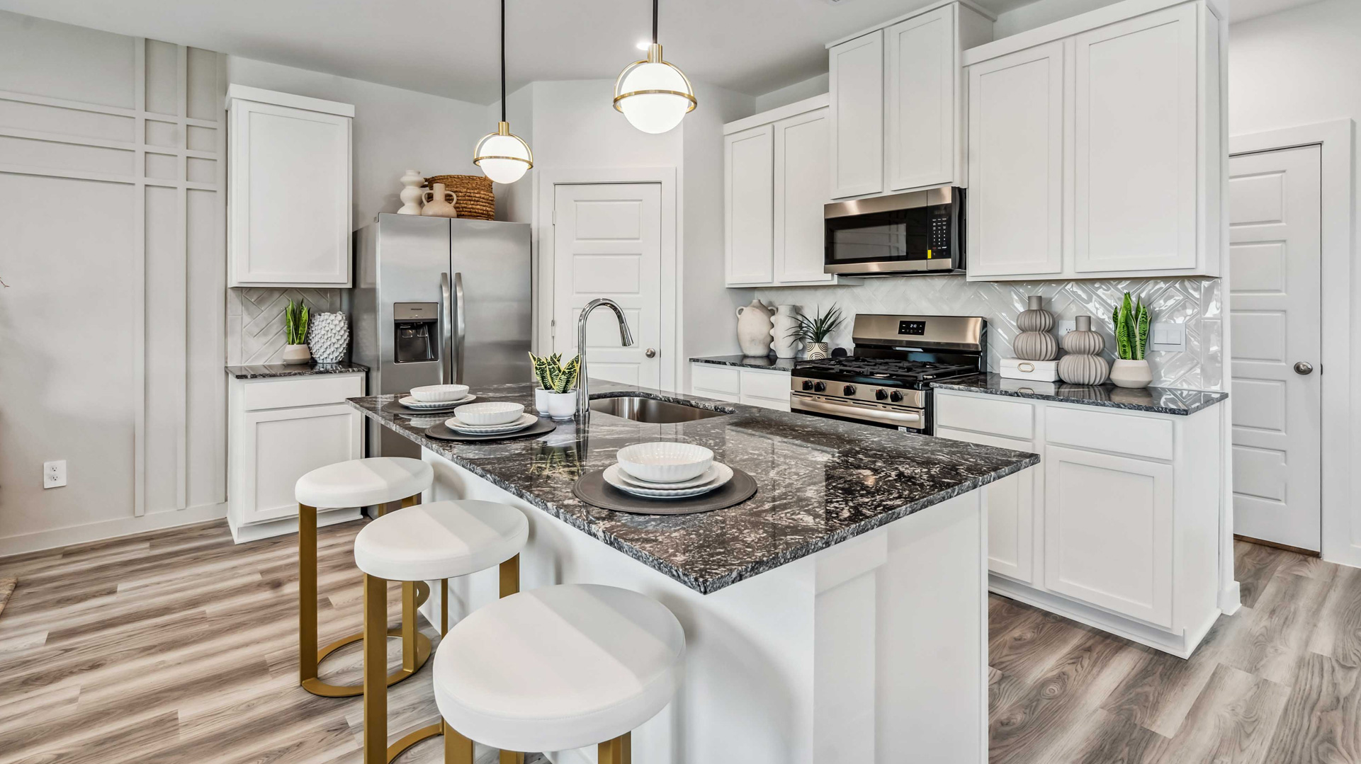 bar seating at the spacious island is the perfect spot for dining and entertaining