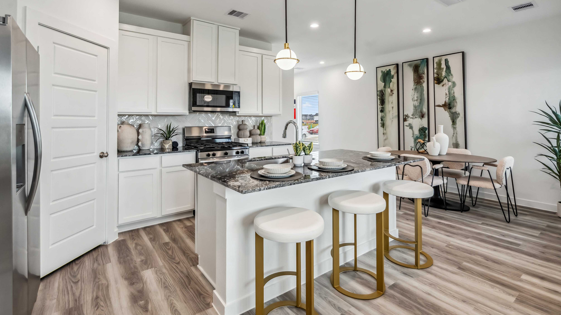 kitchen has beautiful granite counters, light cabinets, white tile backsplash, and stainless steel appliances