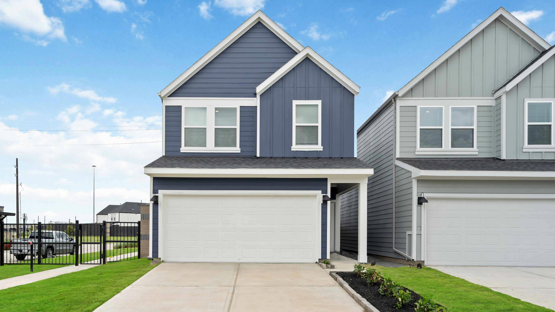 exterior elevation of the jasmine plan, a two story home with two car garage and front porch entry