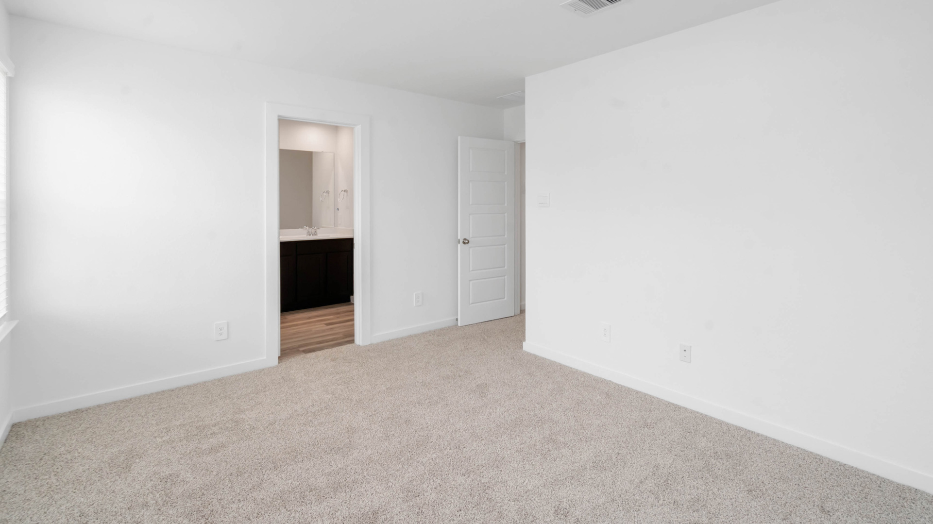 spacious primary suite comfortably fits a king size bed and additional furniture