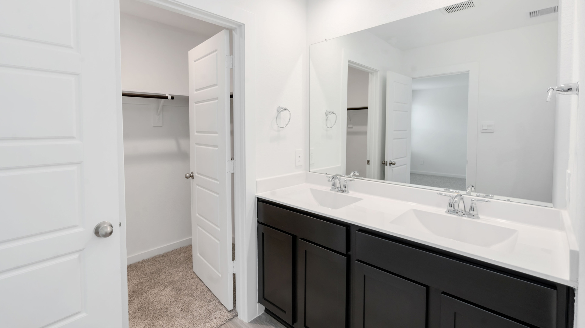 a large mirror is located over the double vanity