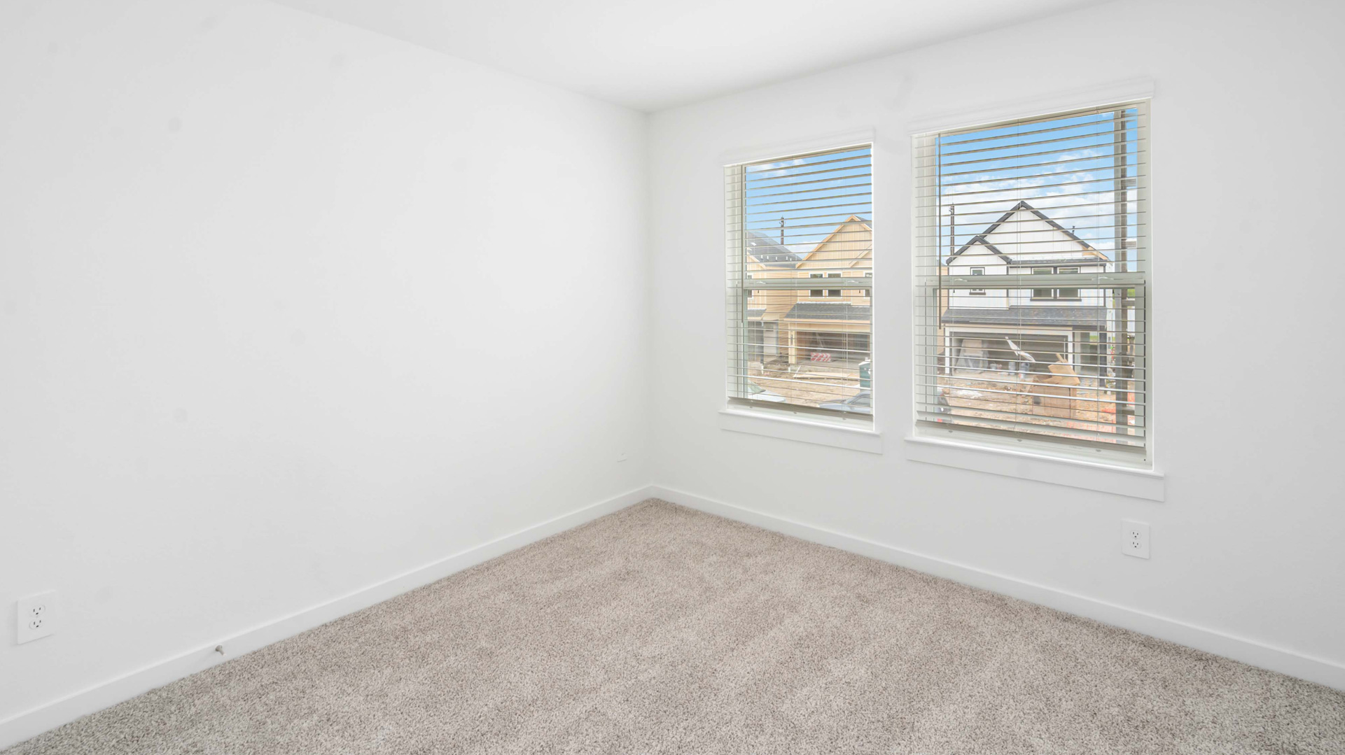 a second bedroom is located down the hall with large windows for natural light