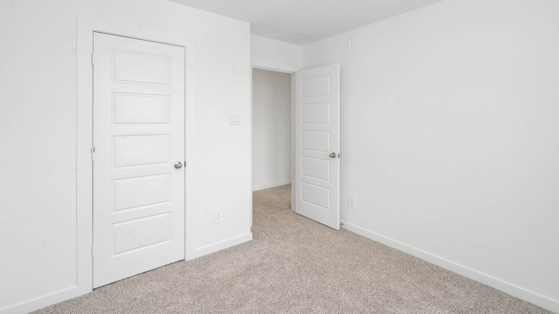 carpet flooring and light neutral walls are in the third bedroom