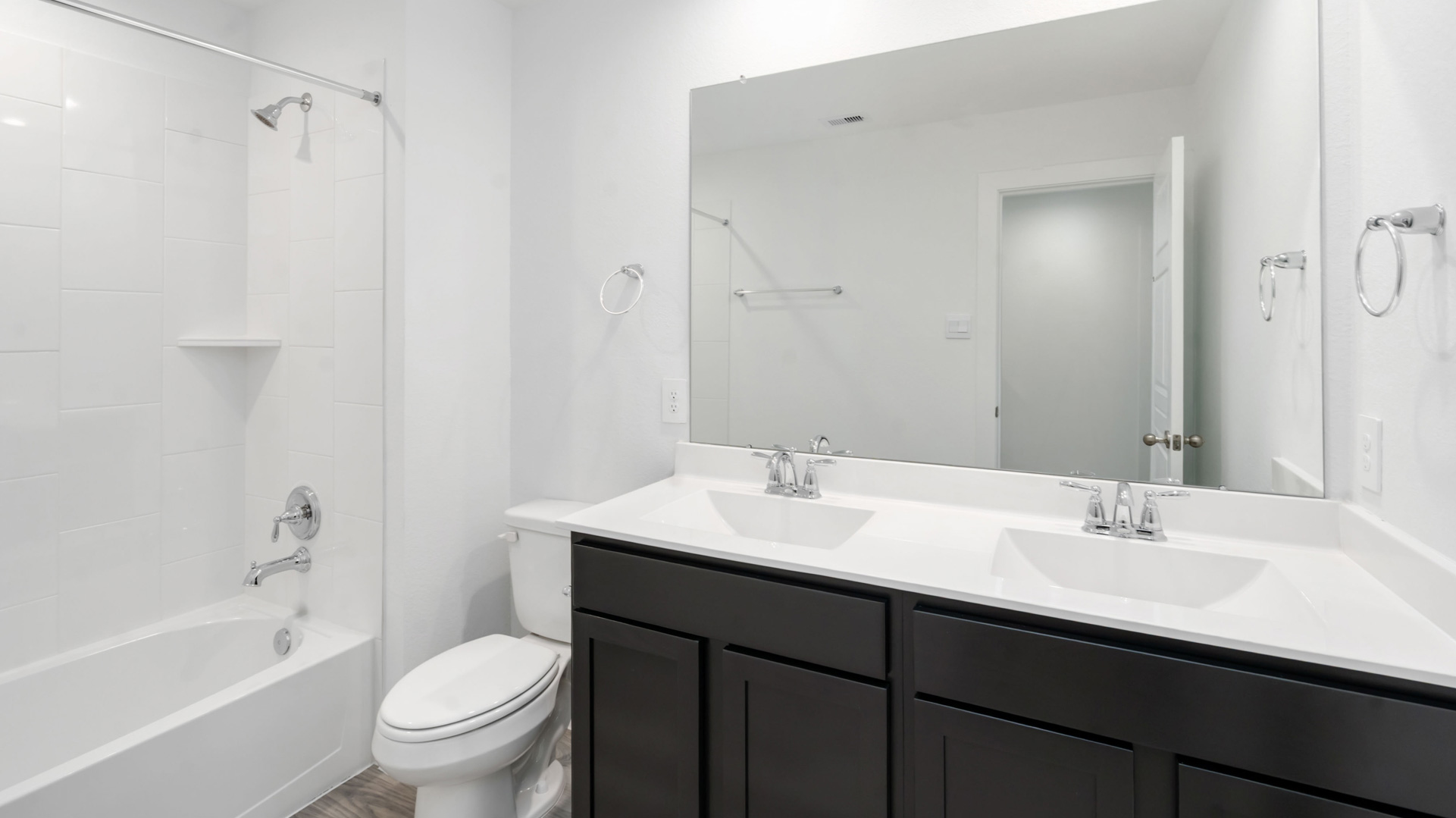 a second full bath is located upstairs with a double vanity and shower/tub insert