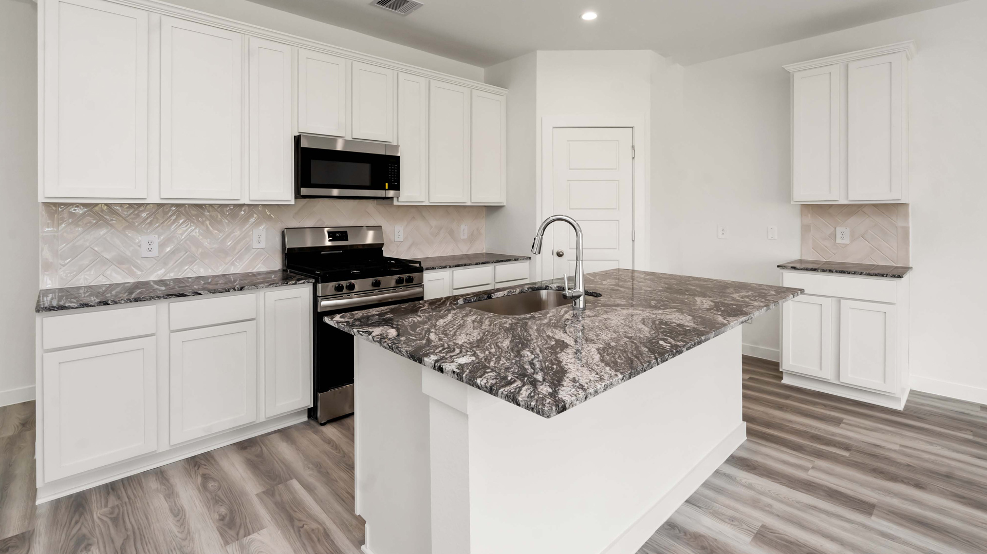 beautiful kitchen with light cabinets, granite counters, and brand new stainless steel appliances that come included in your new home
