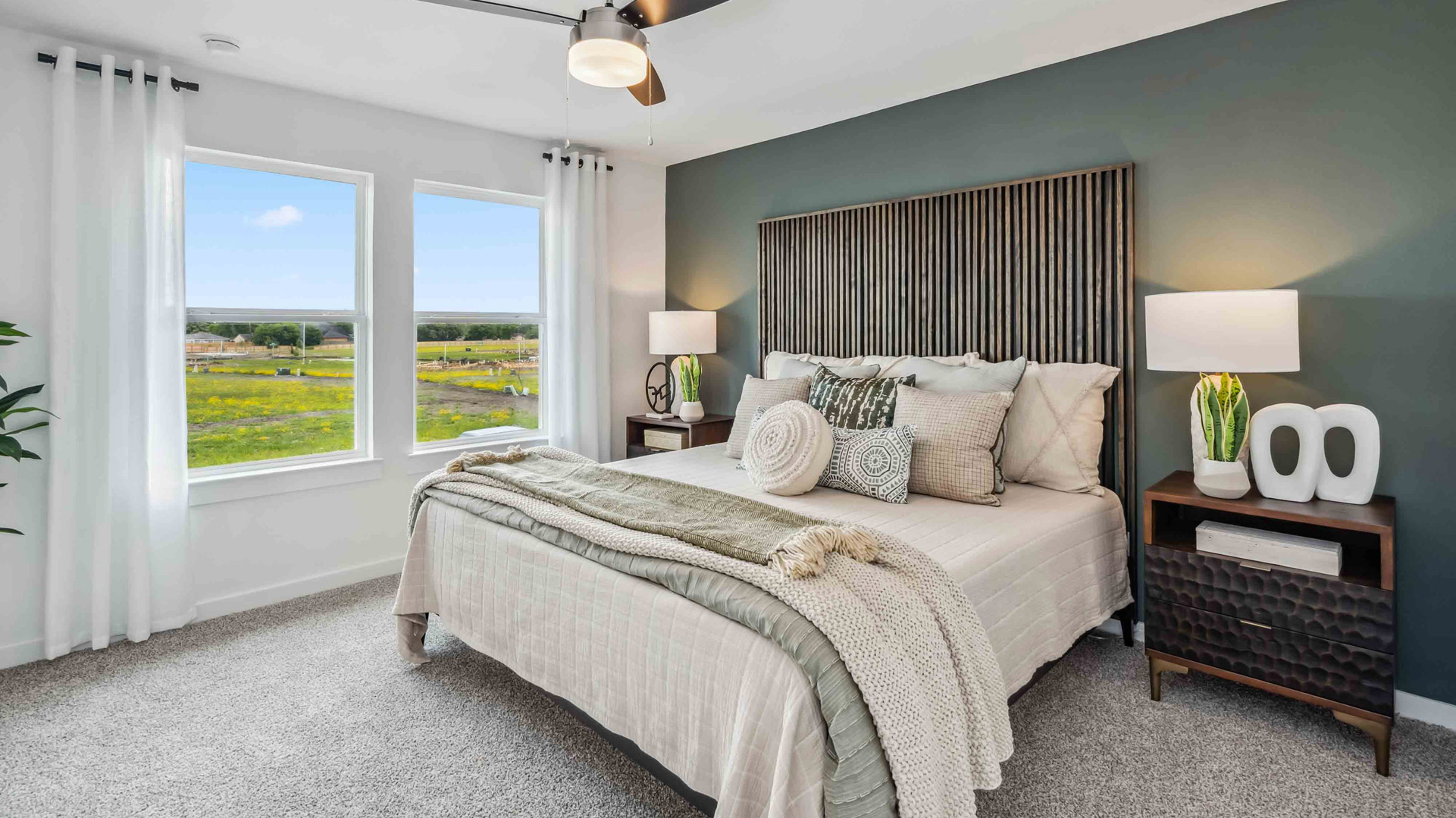 a spacious primary suite comfortably fits a king size bed and additional bedroom furniture