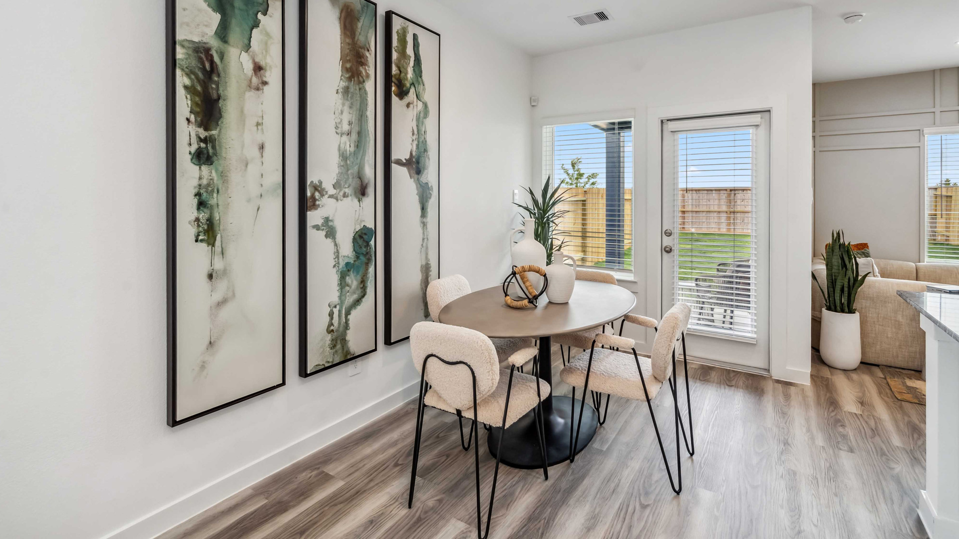 dining area with natural lighting that overlooks the backyard