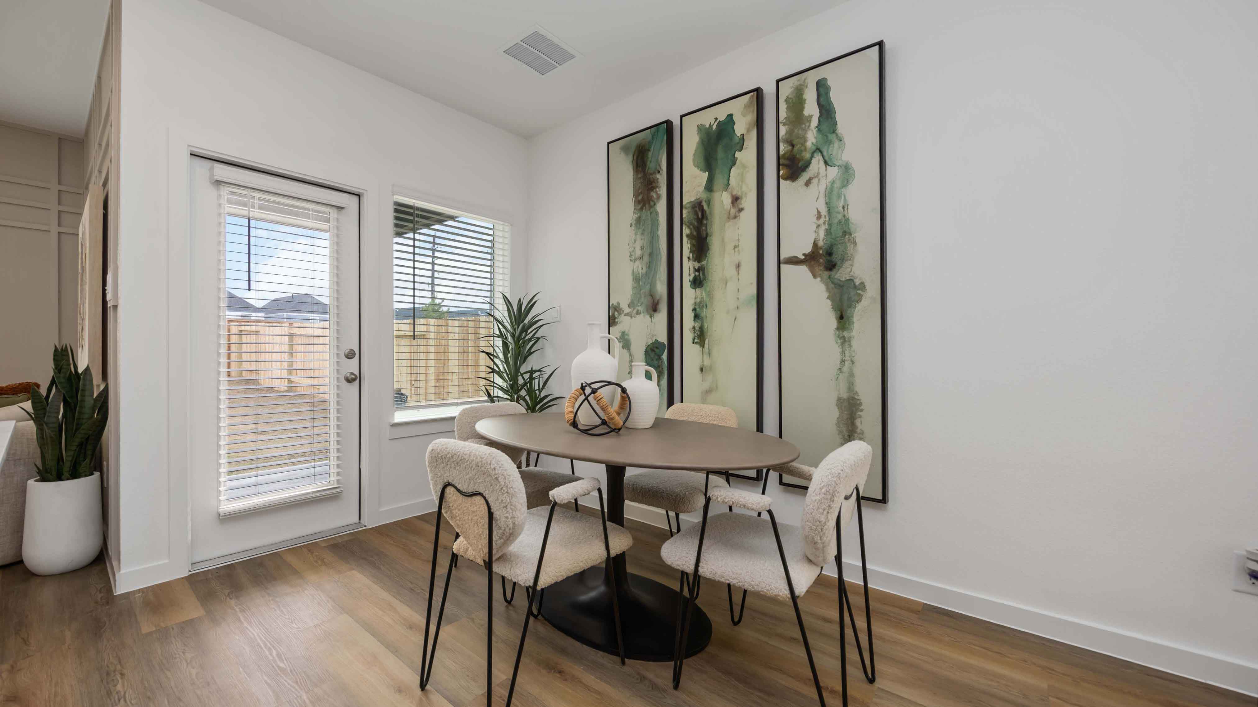 dining area with natural lighting that overlooks the backyard