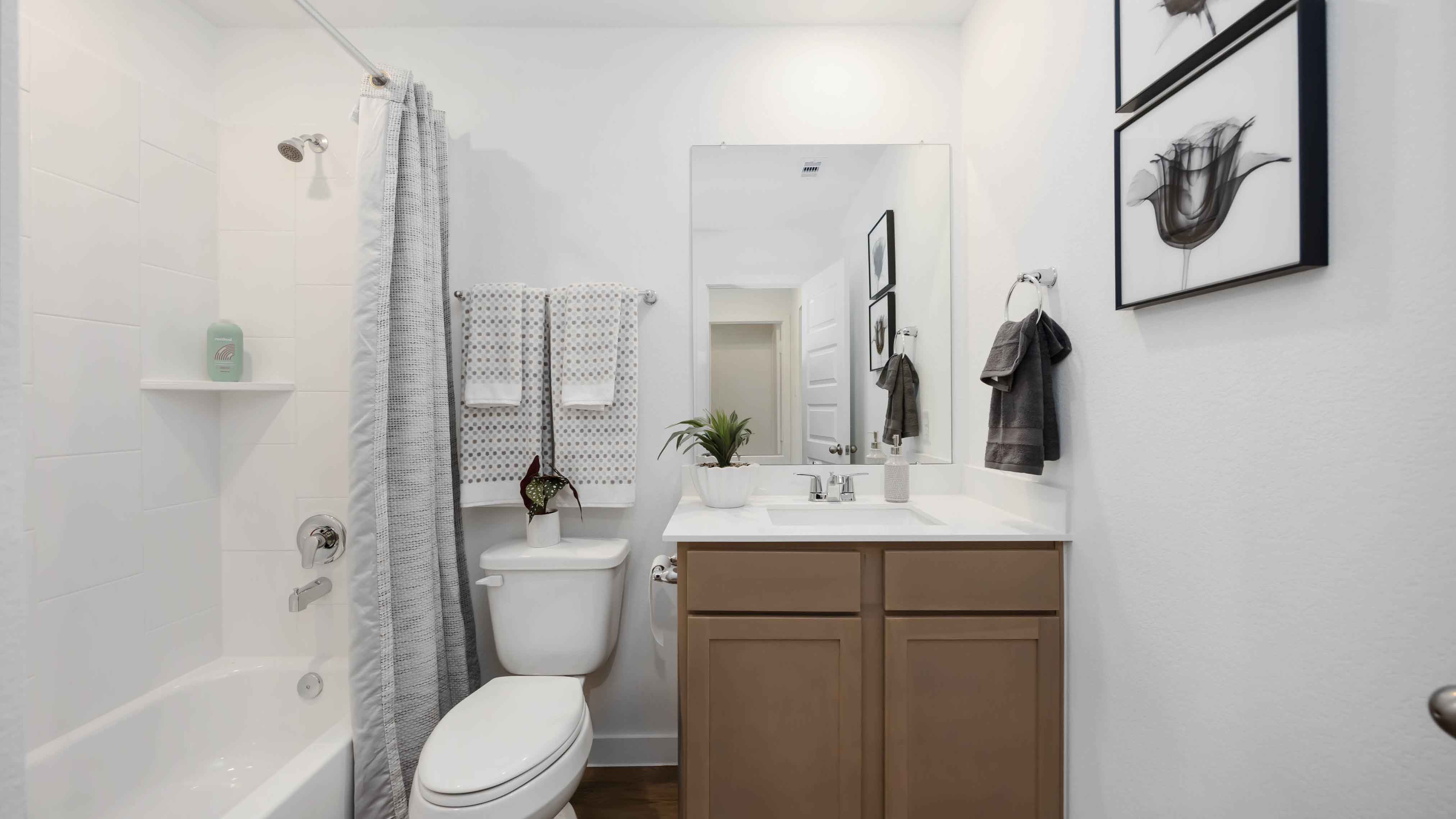a spacious secondary bathroom with one sink vanity and standing tub