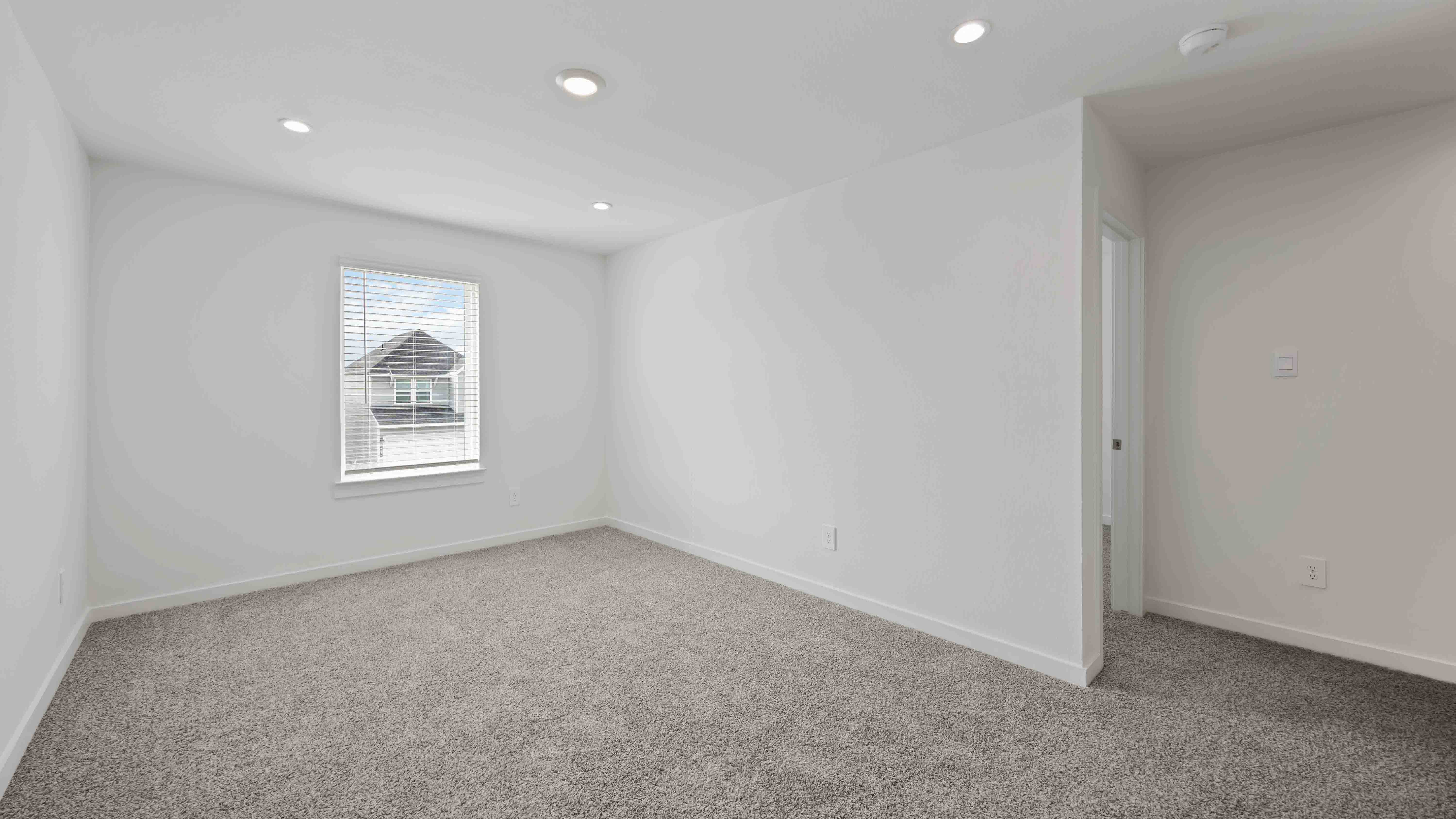 secondary bedroom with neutral walls and carpet flooring