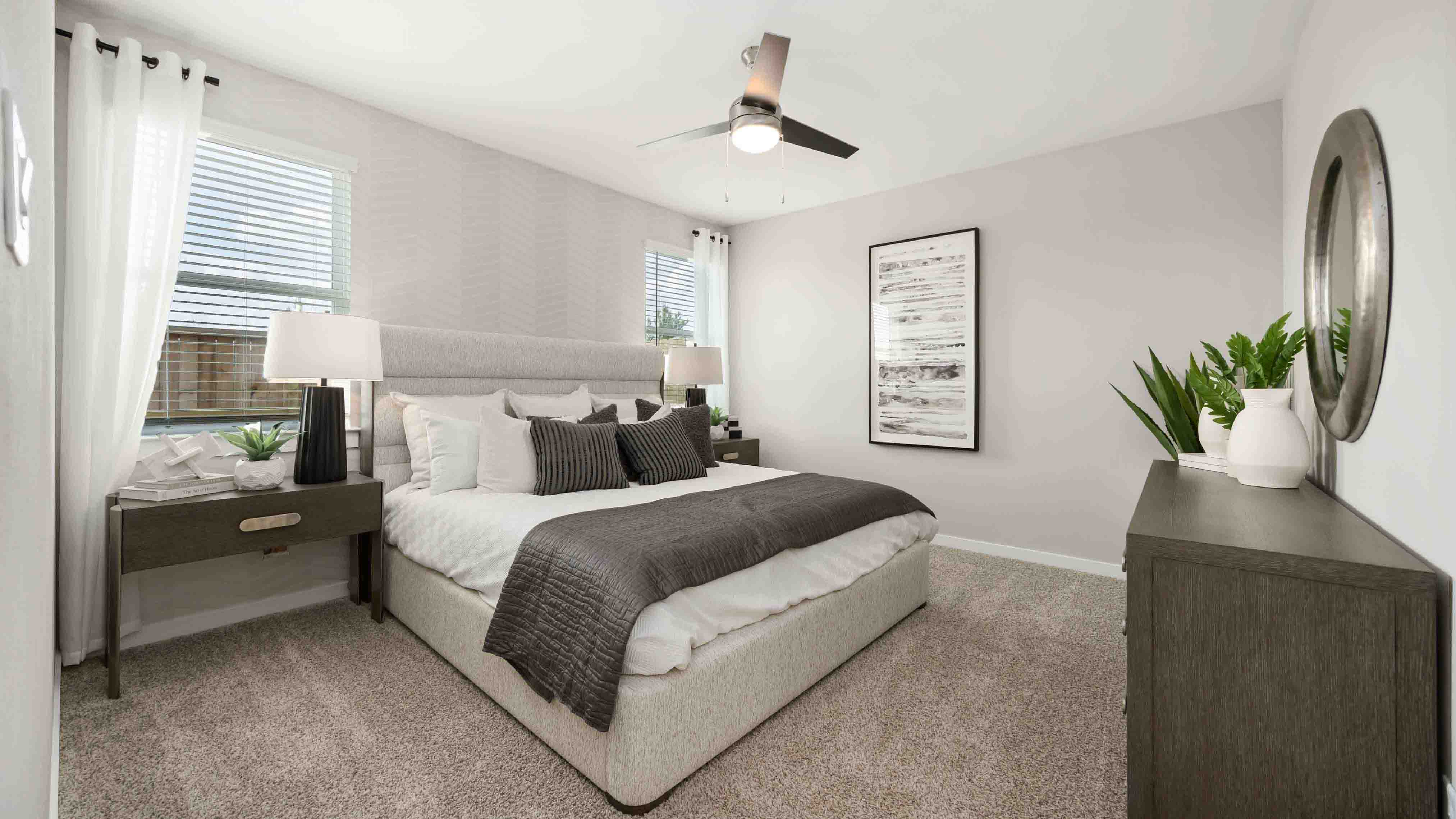 downstairs primary bedroom that comfortably fits a kind size bed and additional bedroom furniture